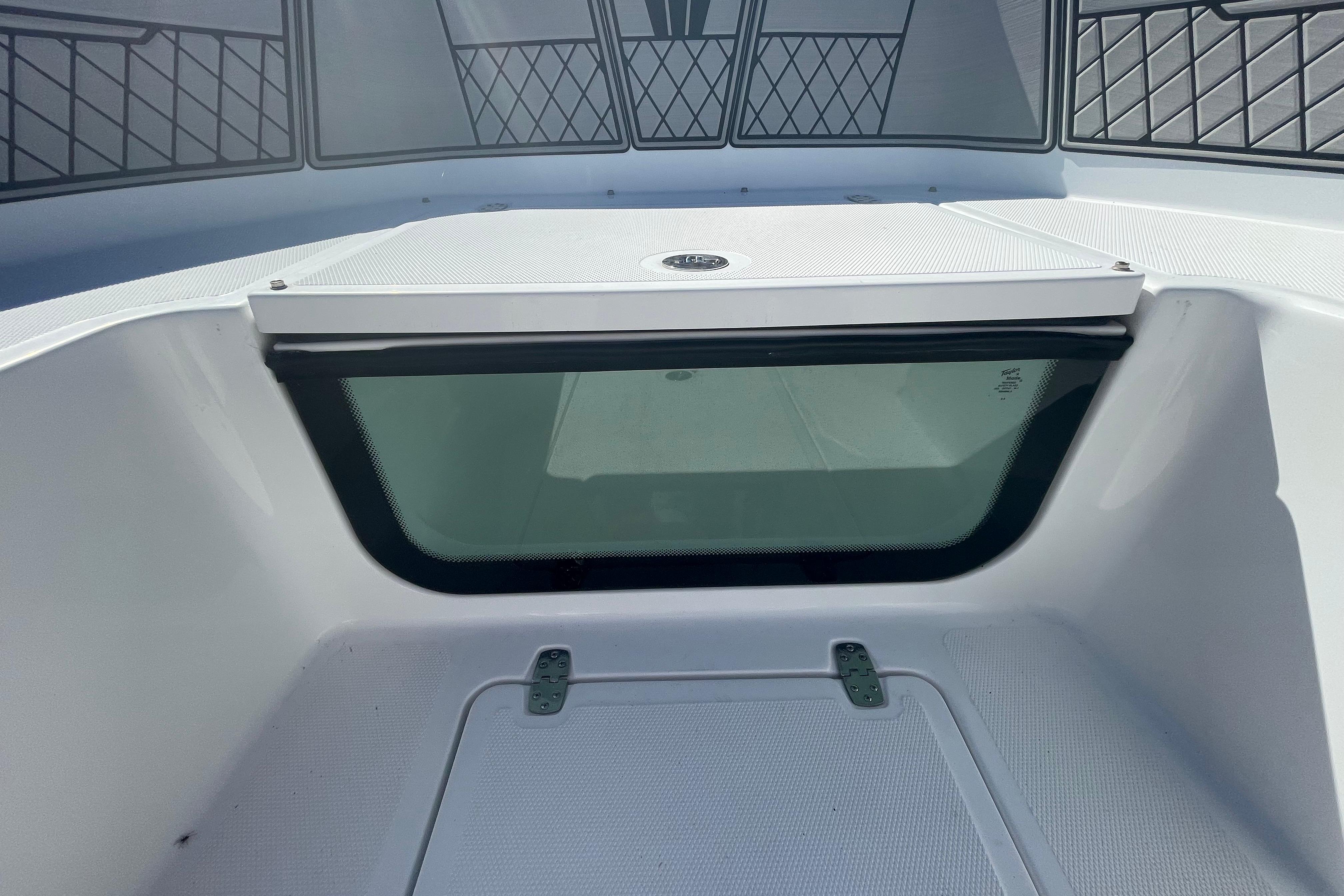 2022 Wellcraft 202 Fisherman boat interior with storage compartment and cushioned seating.
