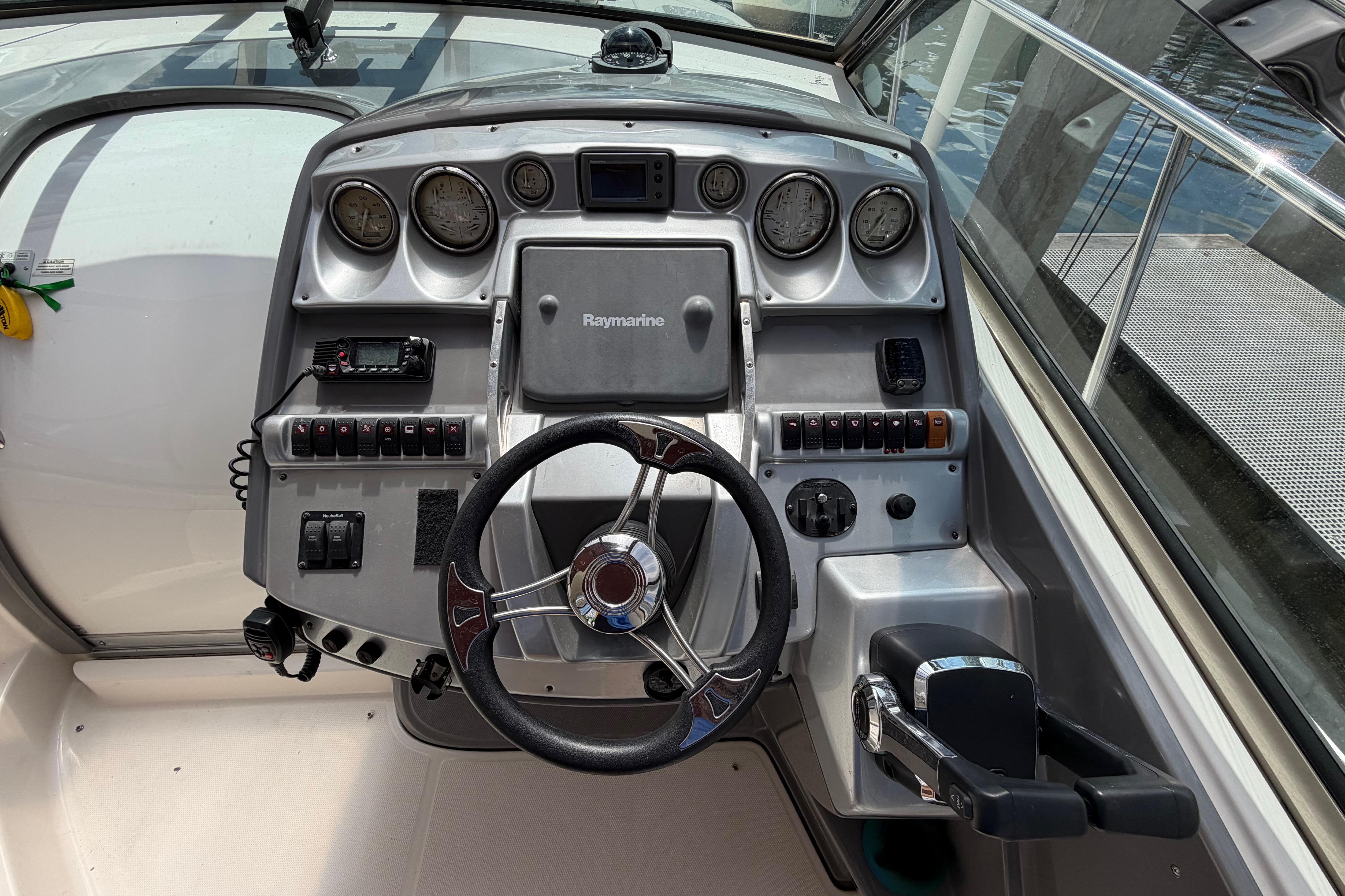 Cockpit of 2007 Monterey 350 Sport Yacht with steering wheel and control panel.
