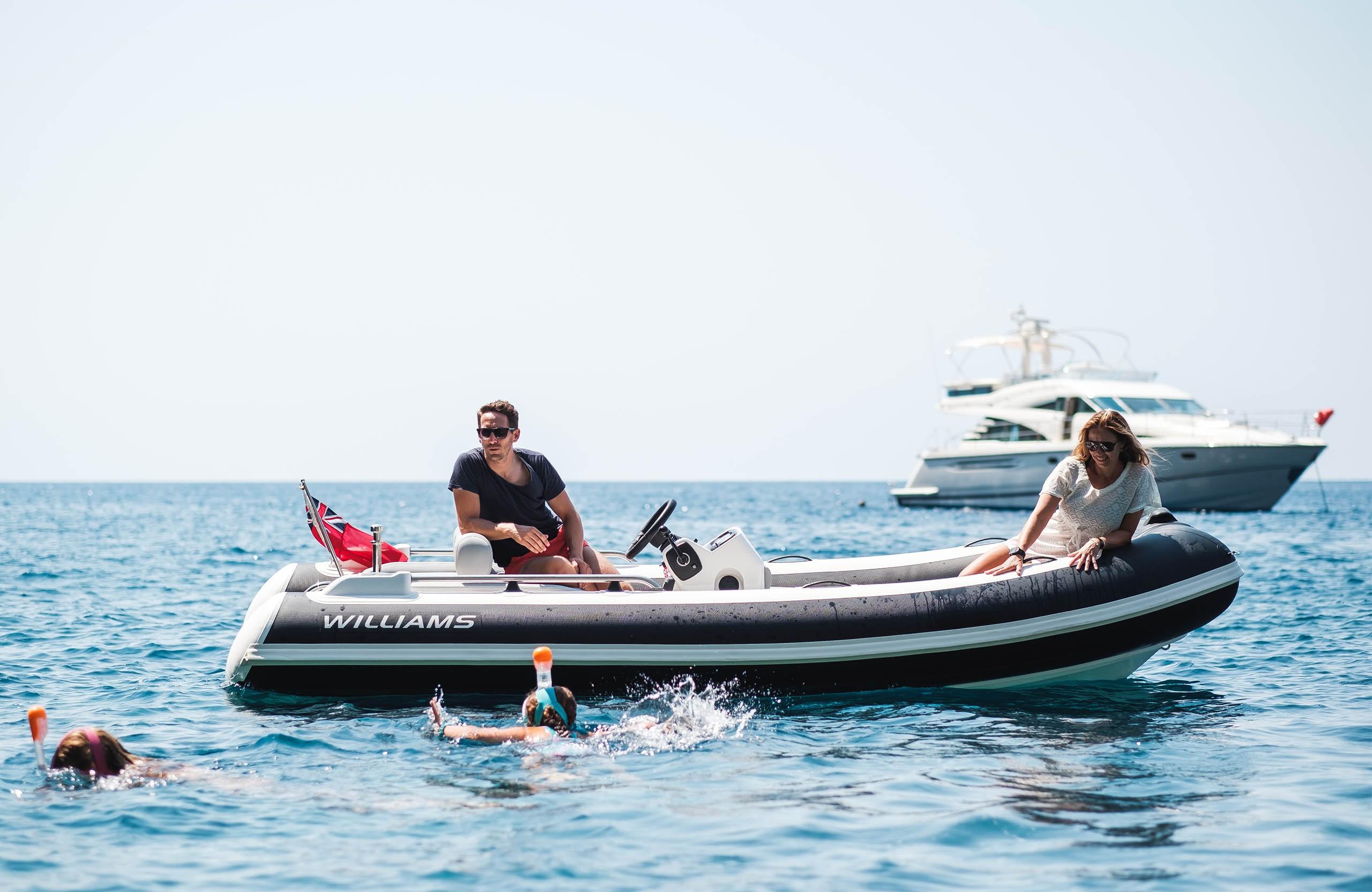 2025 Williams Jet Tenders Sportjet 435 on water with swimmers nearby.
