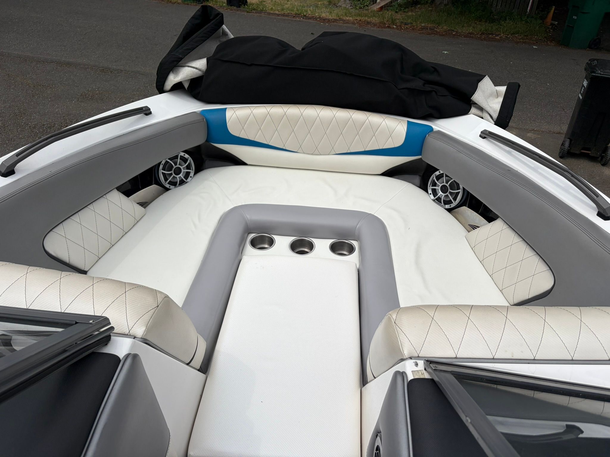 The image shows the interior of a 2016 Tigé RZ2 boat with cushioned seating and cup holders.