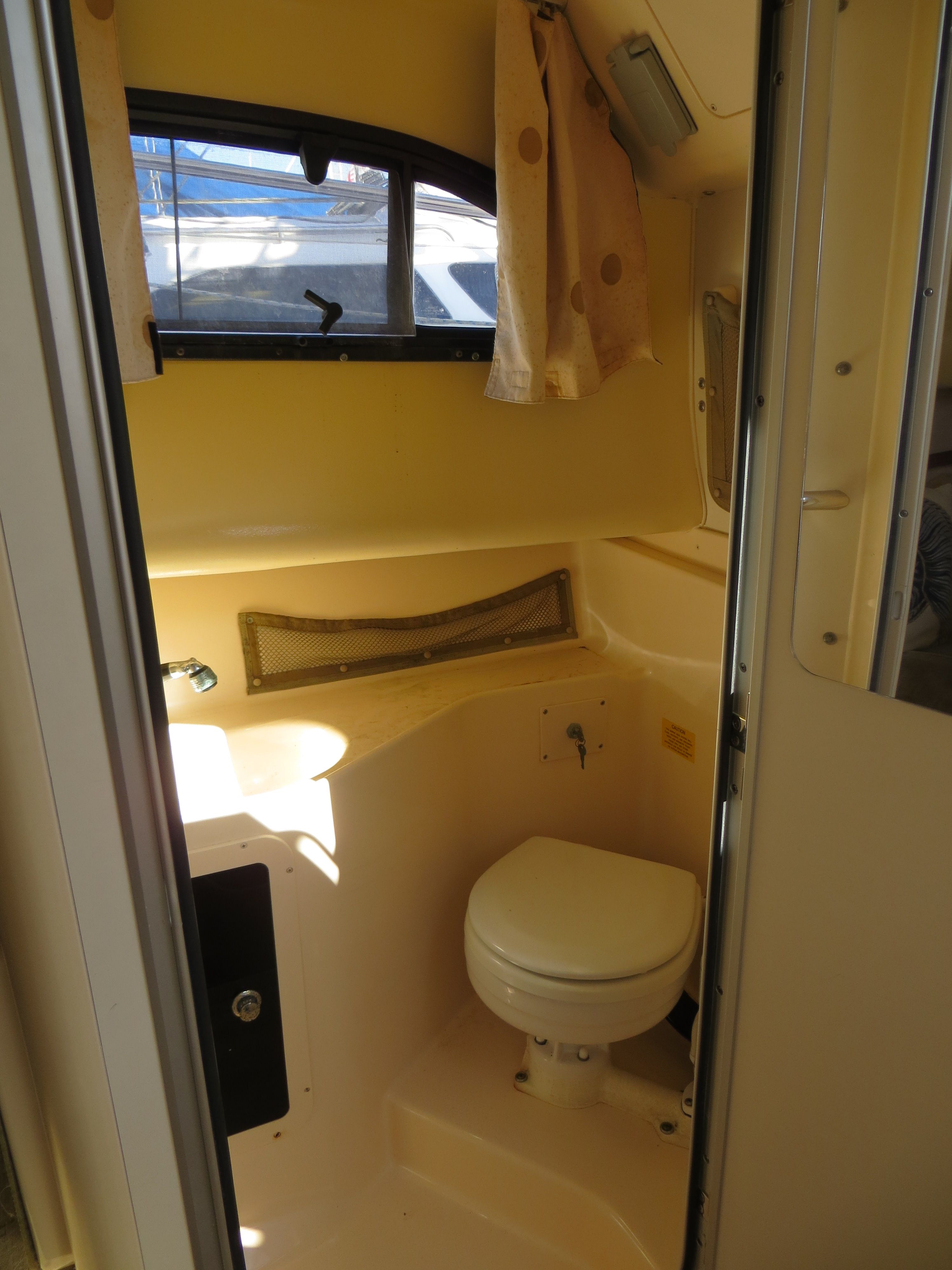 Interior of a 2007 Grady-White Sailfish 282 featuring a toilet and window.