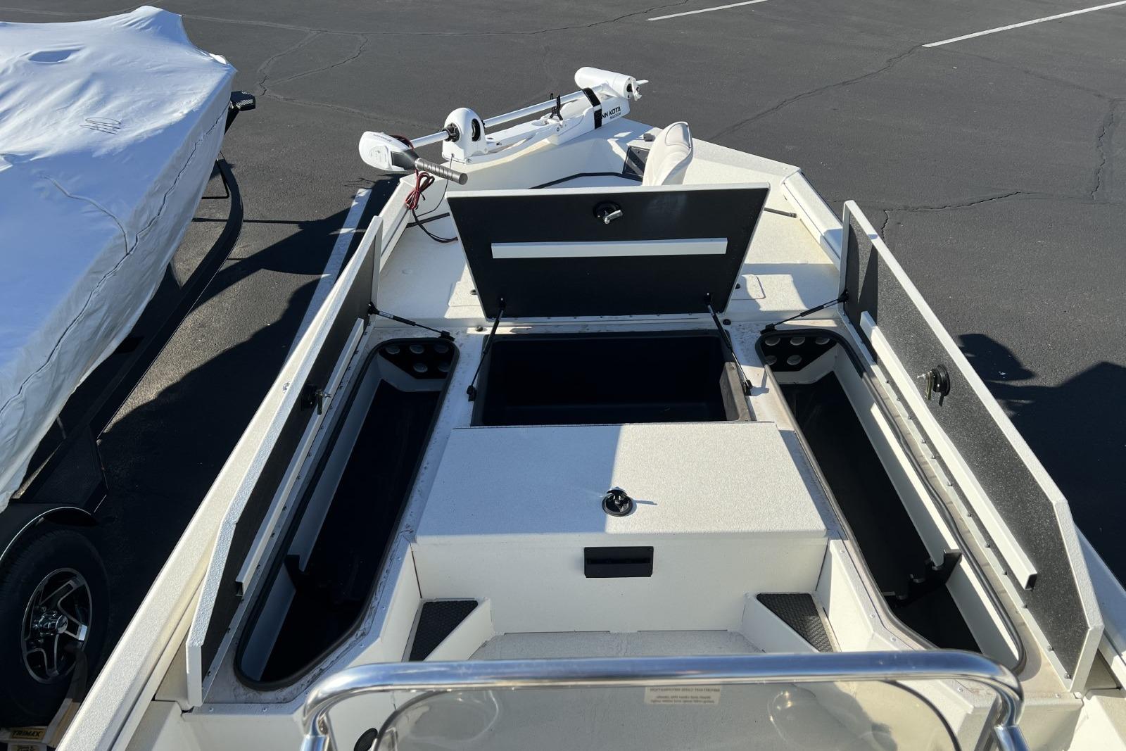 2024 Ranger RB200 boat interior with open storage compartments in a parking lot.