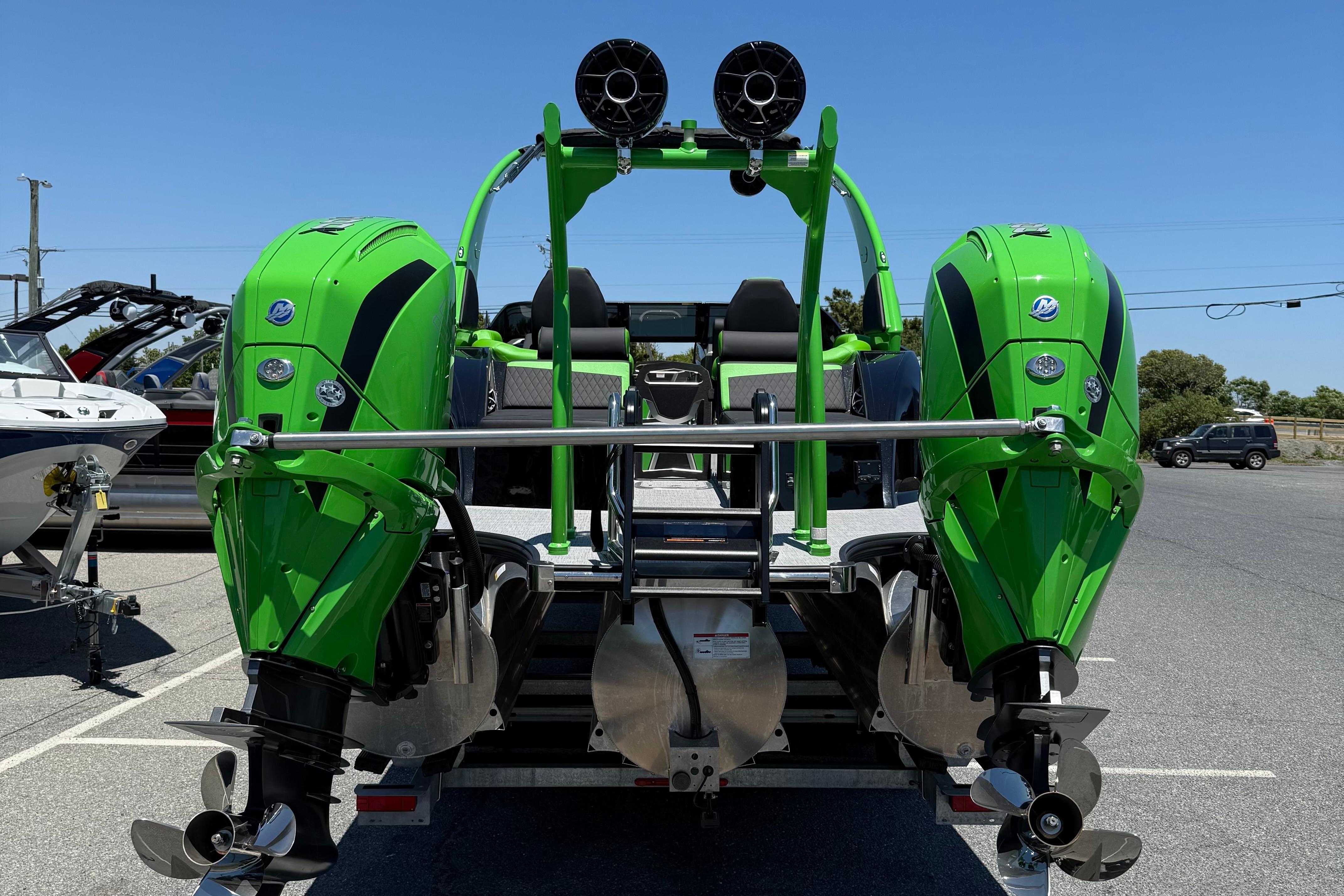 2026 Berkshire Sport SLX9 DC boat with dual green outboard motors in a parking lot.