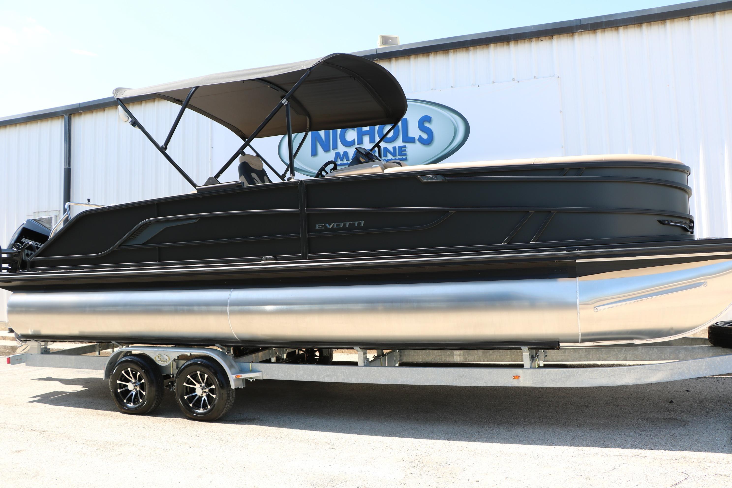 2026 Evotti 725 CS Tri-Toon boat on trailer at Nichols Marine dealership.