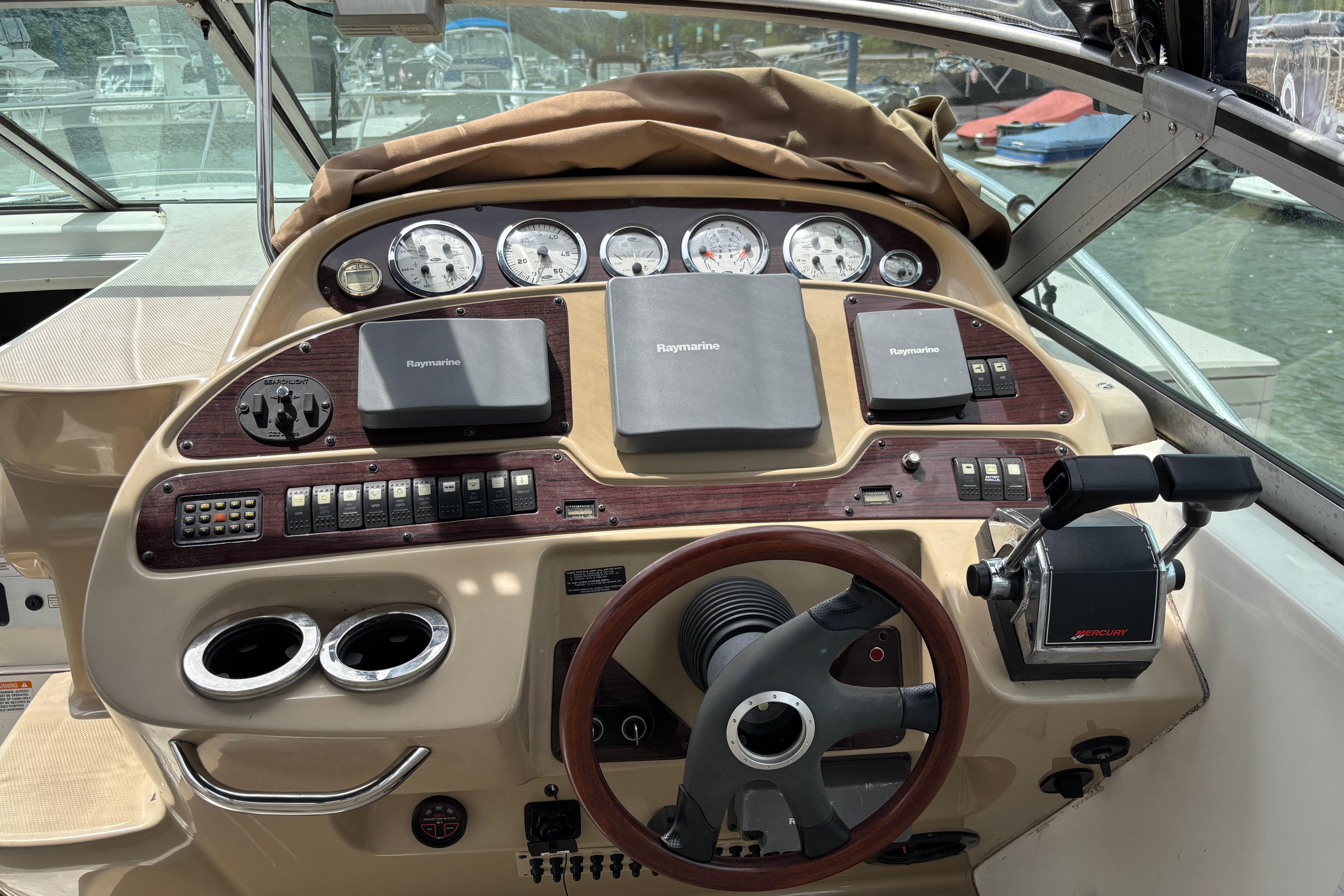 2004 Chaparral Signature 330 boat dashboard with Raymarine navigation equipment and Mercury controls.