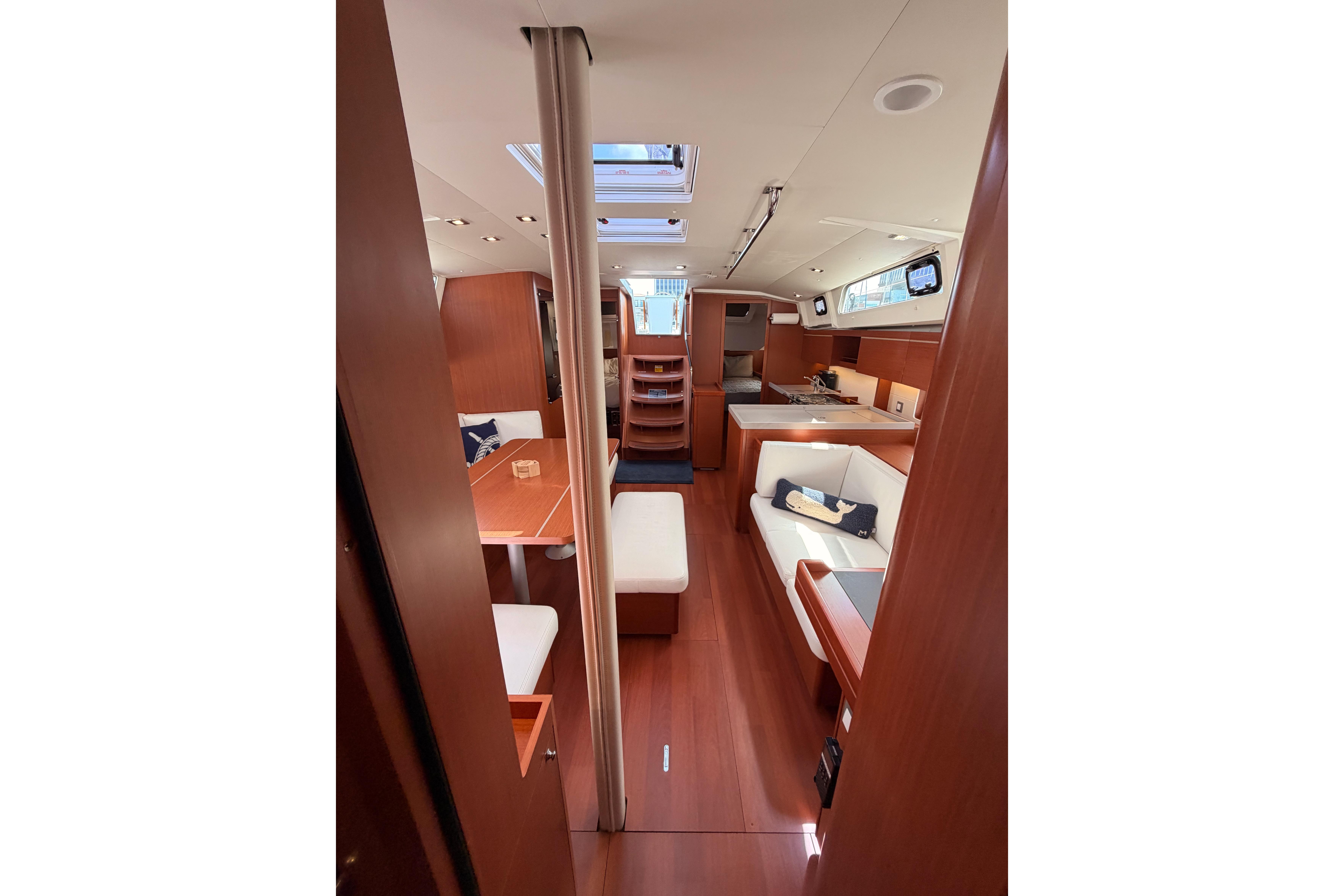 Interior of 2020 Beneteau Oceanis 46.1 yacht, featuring elegant wood finishes and modern design.