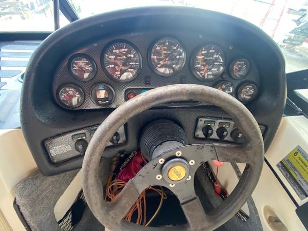 1998 Malibu Response boat dashboard with steering wheel and instrument gauges.