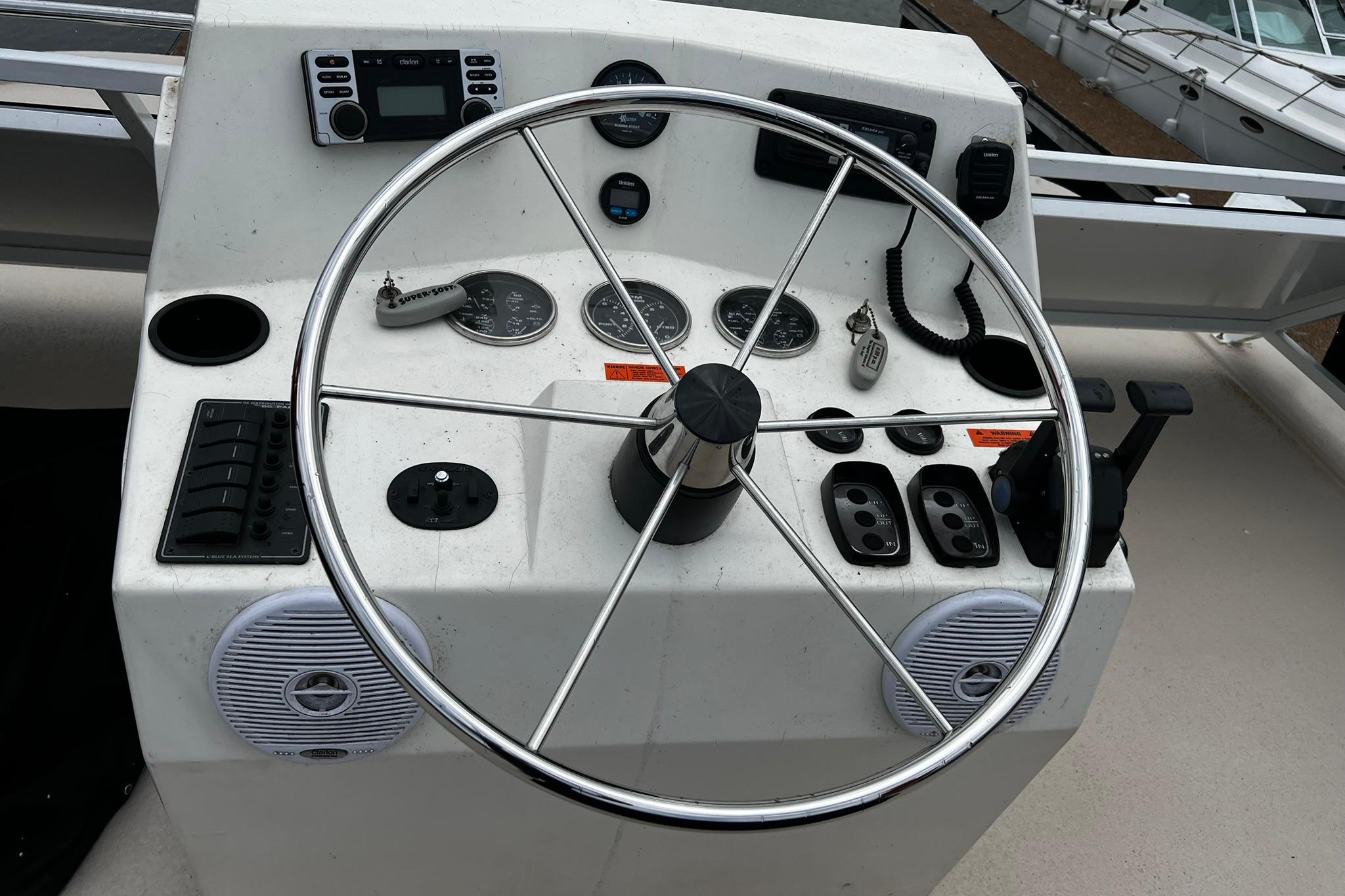 Helm of 2010 Skipperliner 480 Flybridge with steering wheel and control panel.