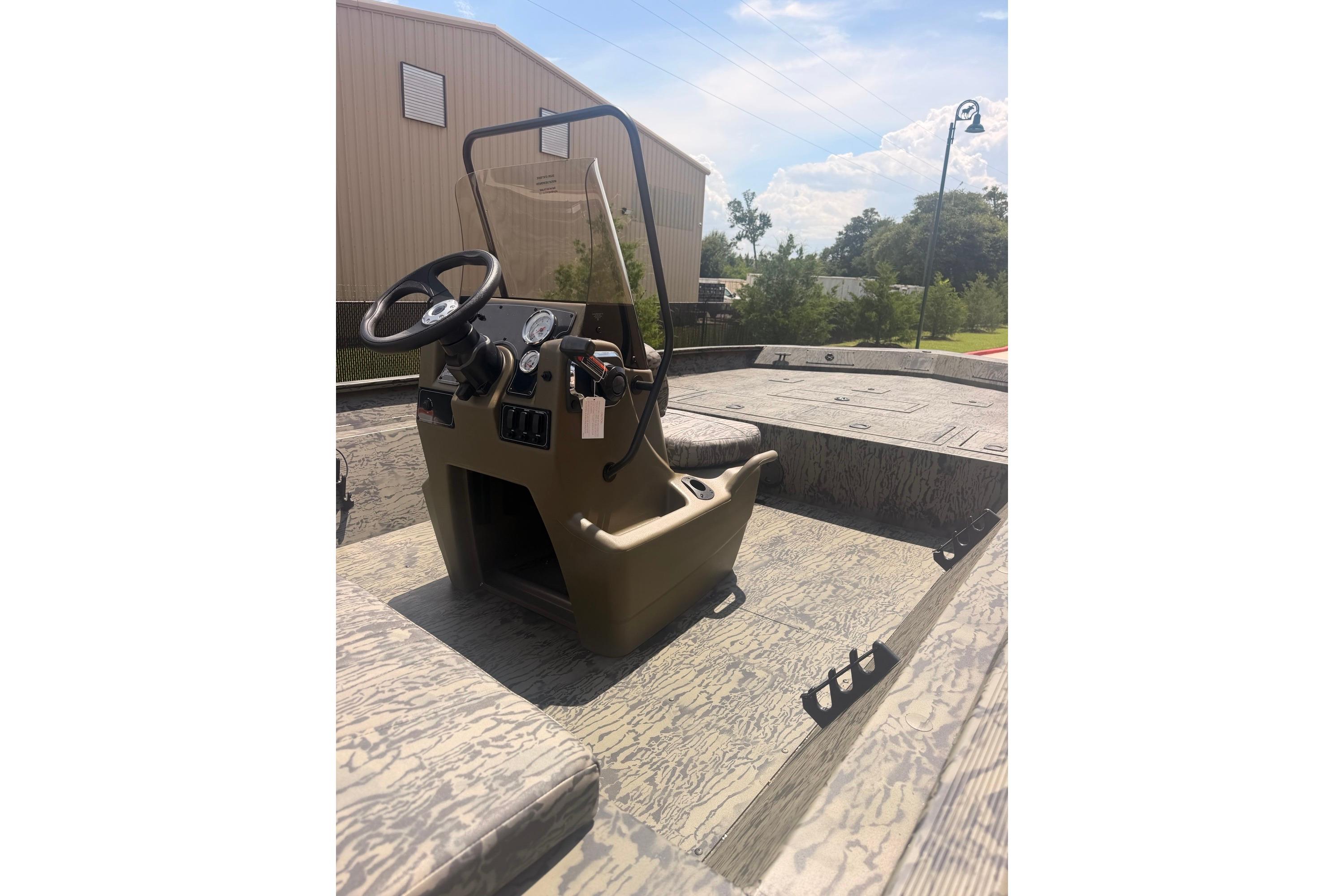 2026 Tracker Grizzly 2072 CC boat interior with steering console and camouflage design.