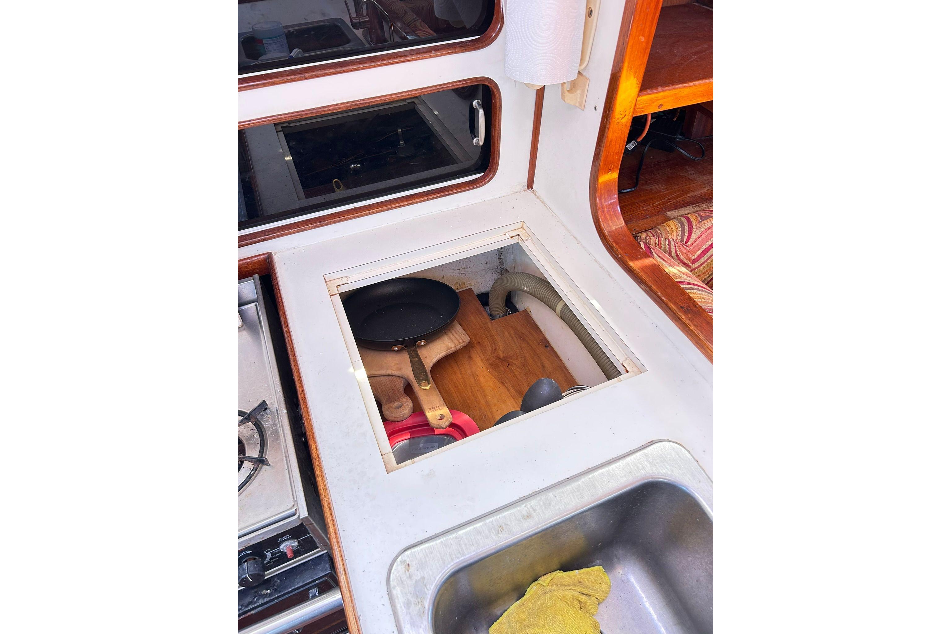1987 Gulfstar CSY 50 Pilot House kitchen with stove, sink, and storage compartment.
