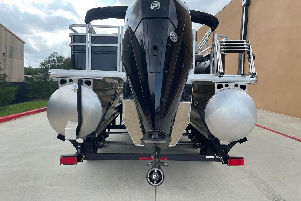 2026 Sun Tracker Fishin' Barge 22 XP3 pontoon boat rear view with motor and pontoons.