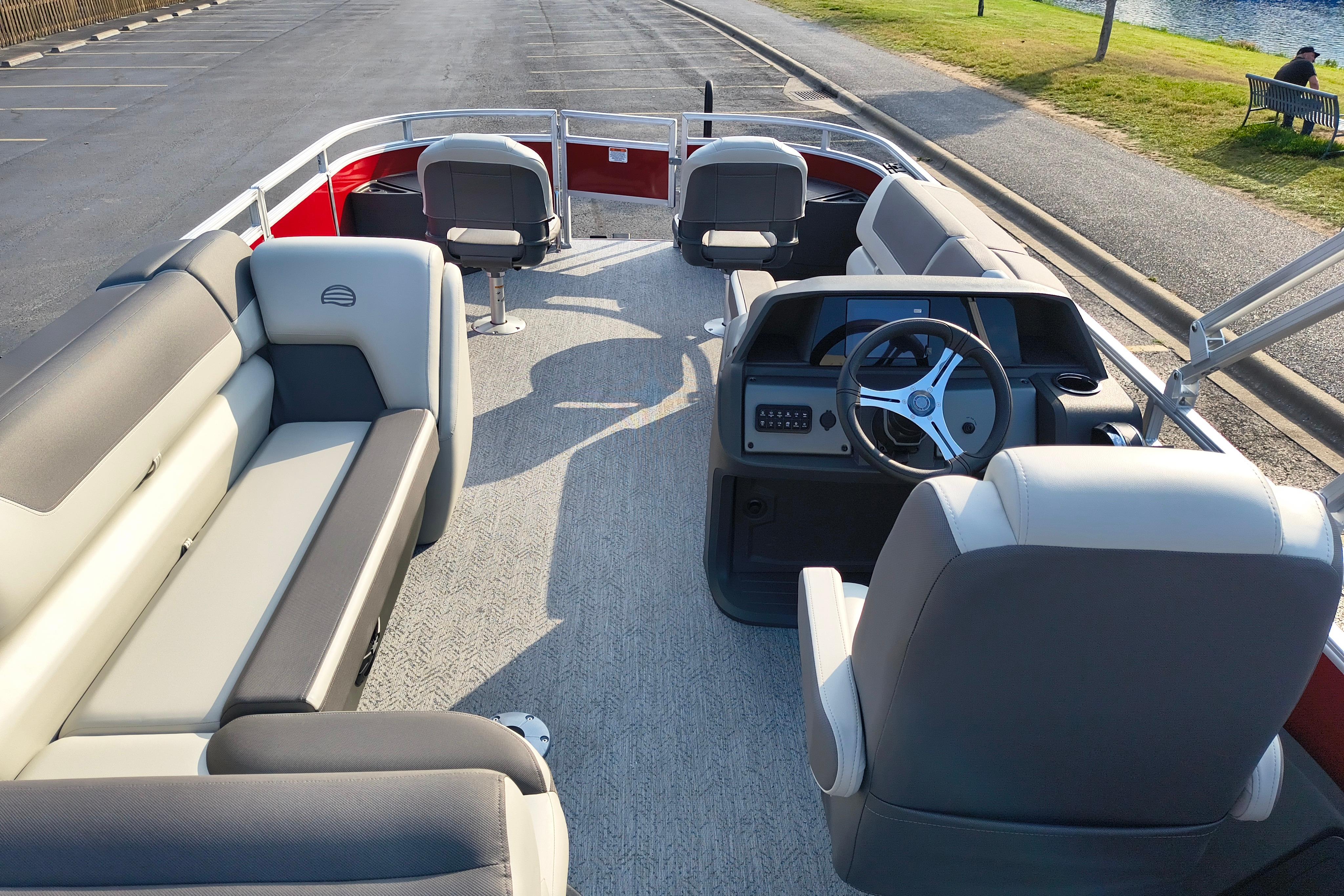2026 Sun Tracker Fishin' Barge 22 DLX interior with seating and steering console.
