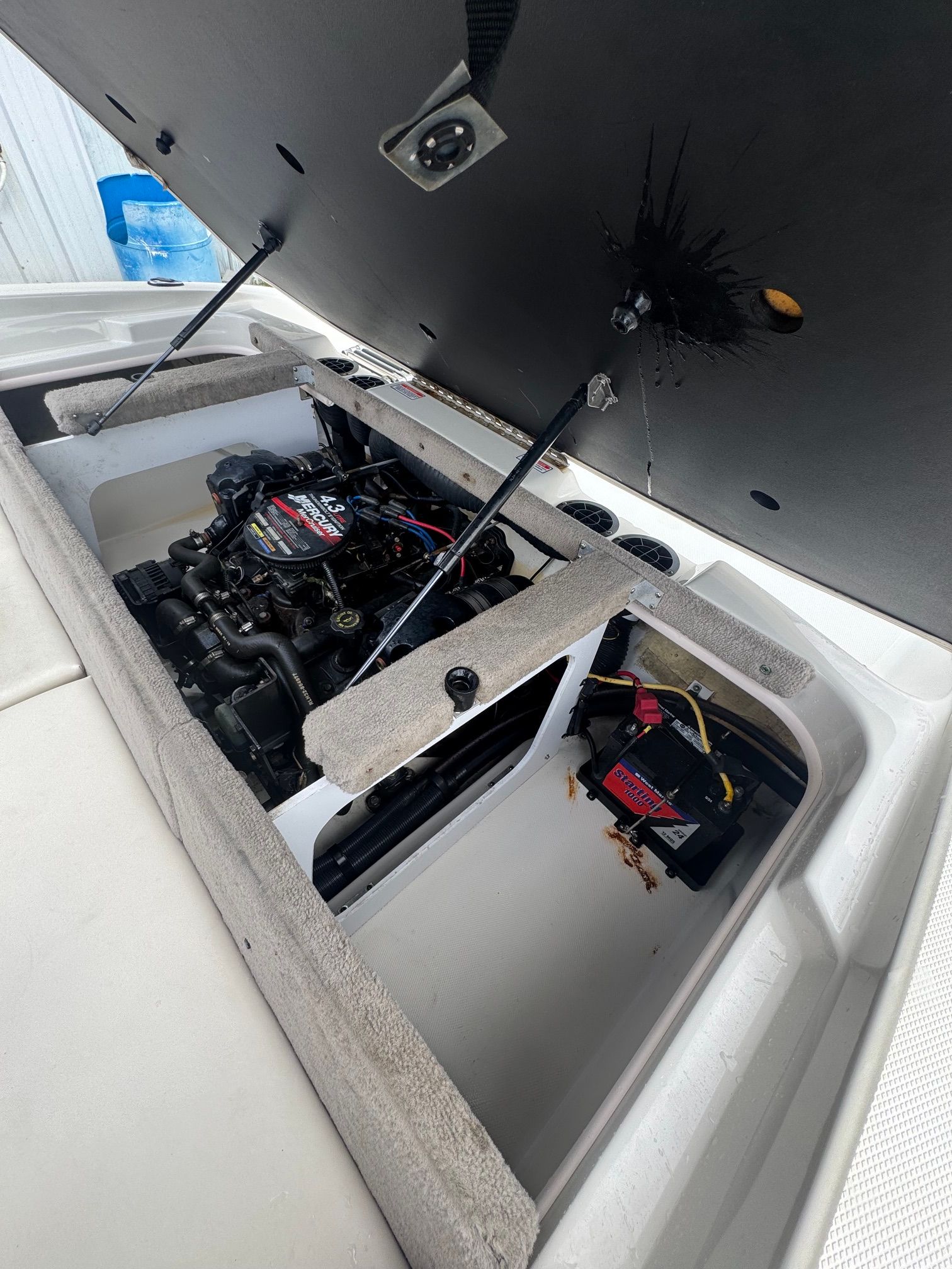 Engine compartment of a 2005 Sea Ray 185 Sport with open hatch.