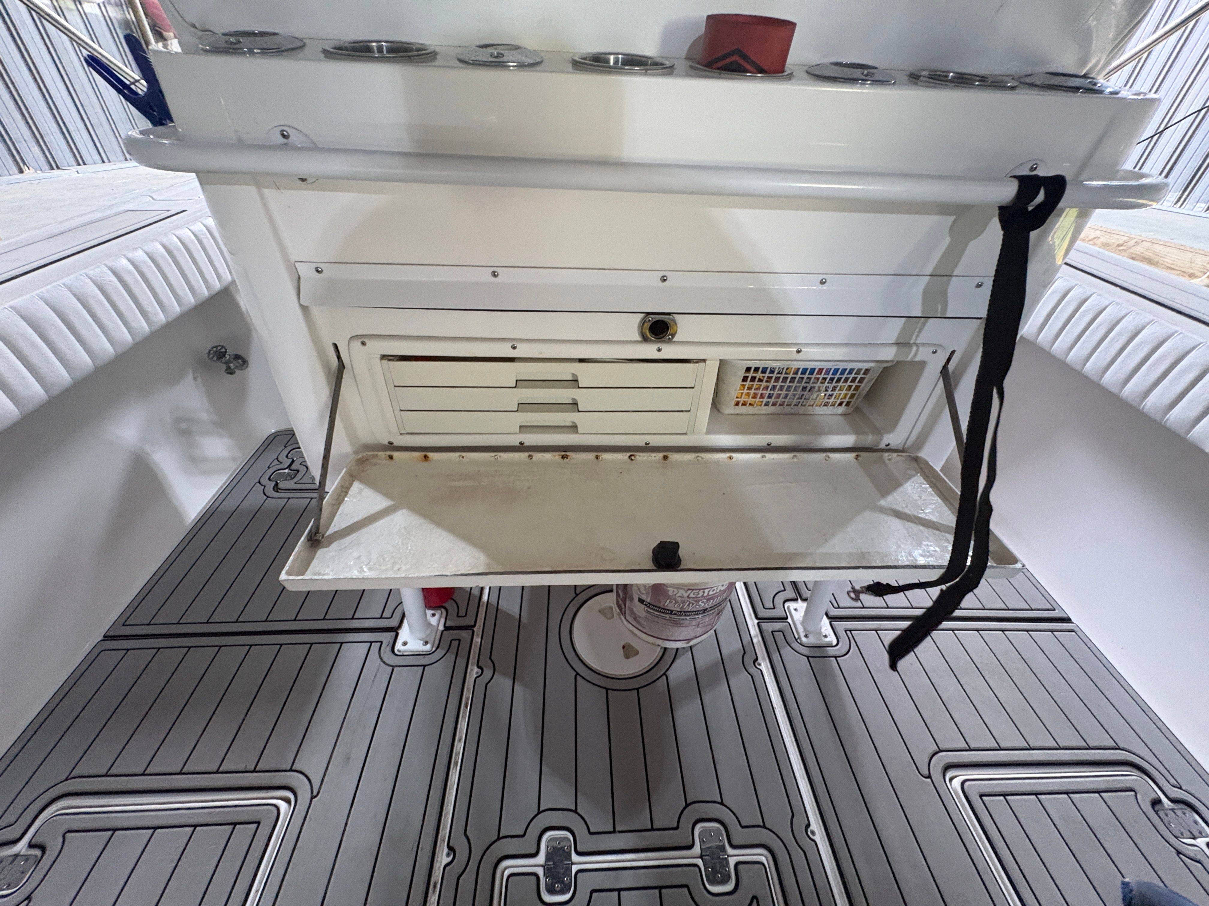Intrepid 322 Cuddy Center Console 2002, interior view with storage compartment.