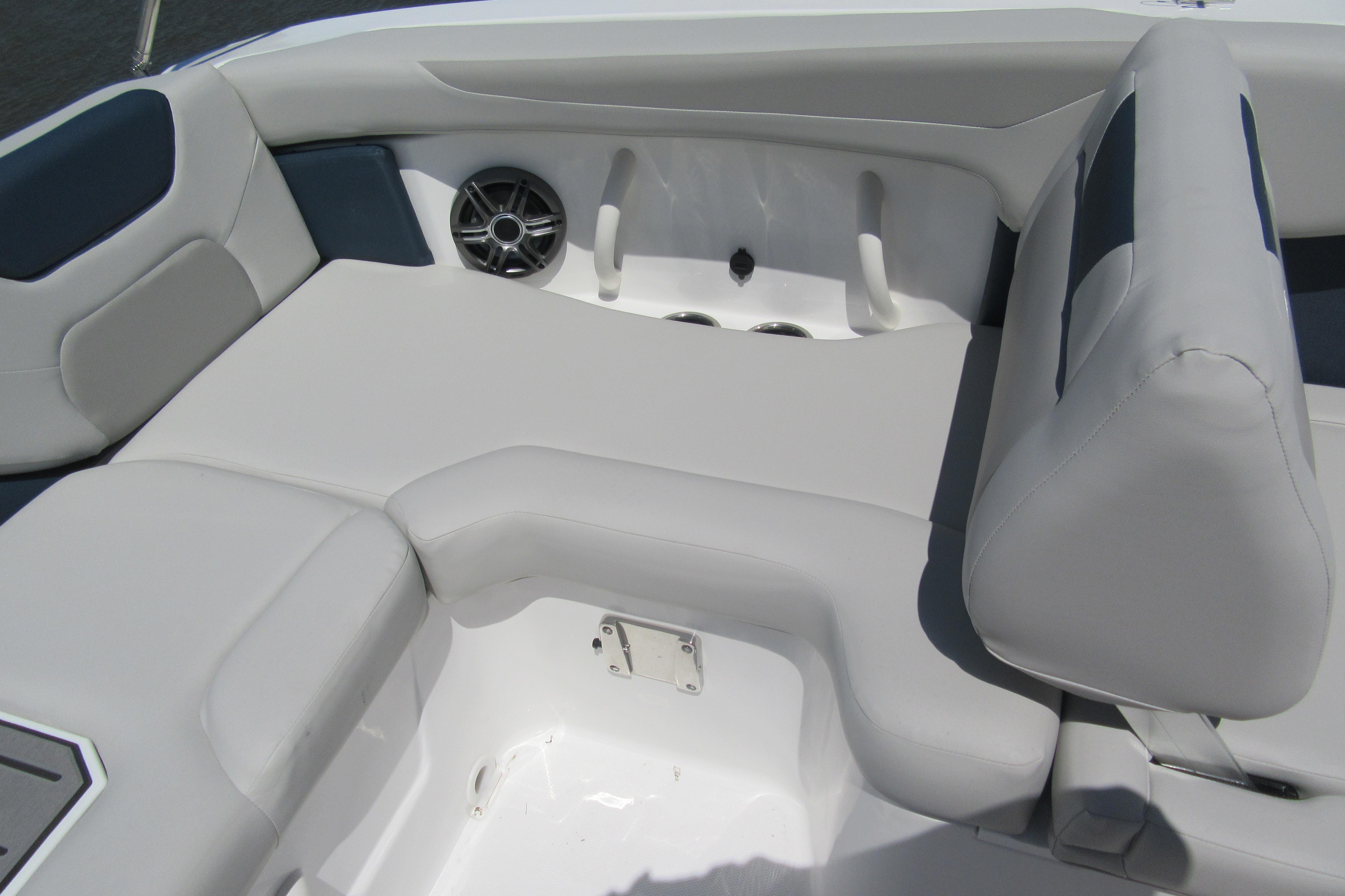 2027 Hurricane SunDeck 2050 OB boat interior with cushioned seating and speaker.