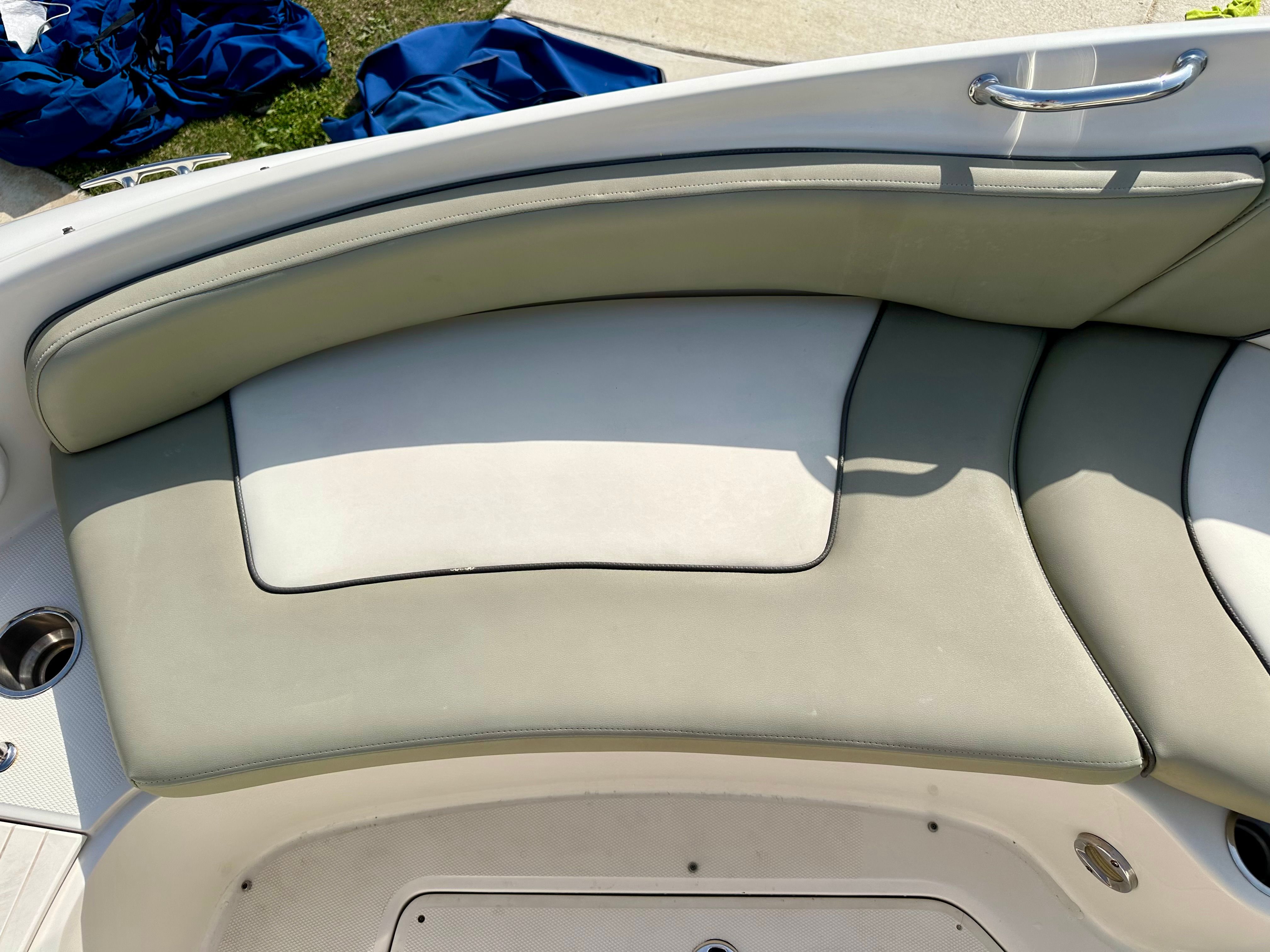 Interior of a 2006 Sea Ray 240 Sundeck boat with cushioned seating.