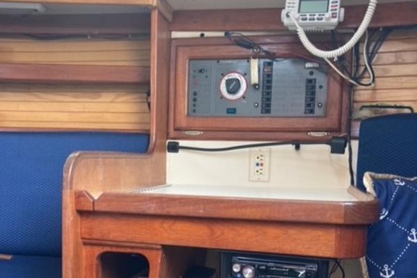 Navigation station inside a 1989 Catalina 30 sailboat with control panel and radio.