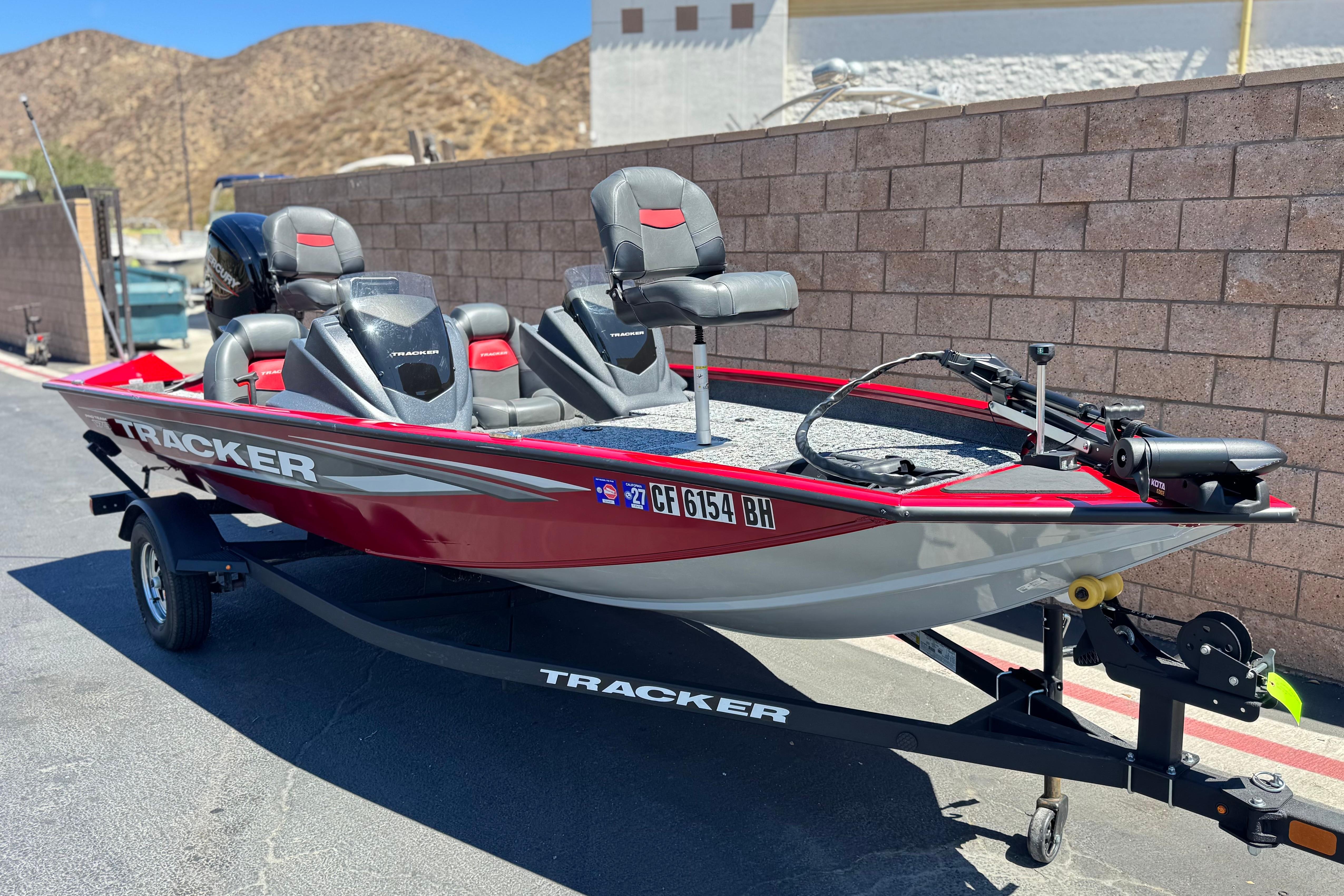 2025 Tracker Pro Team 175 TXW fishing boat on trailer, parked outdoors.