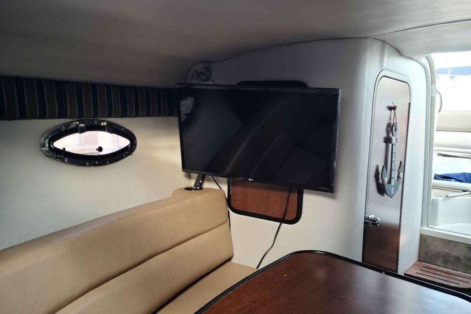 Interior of 2016 Crownline 264 CR boat with TV and seating area.