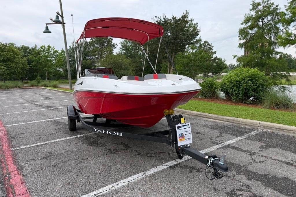 2026 Tahoe T16 boat with red canopy on trailer in parking lot.