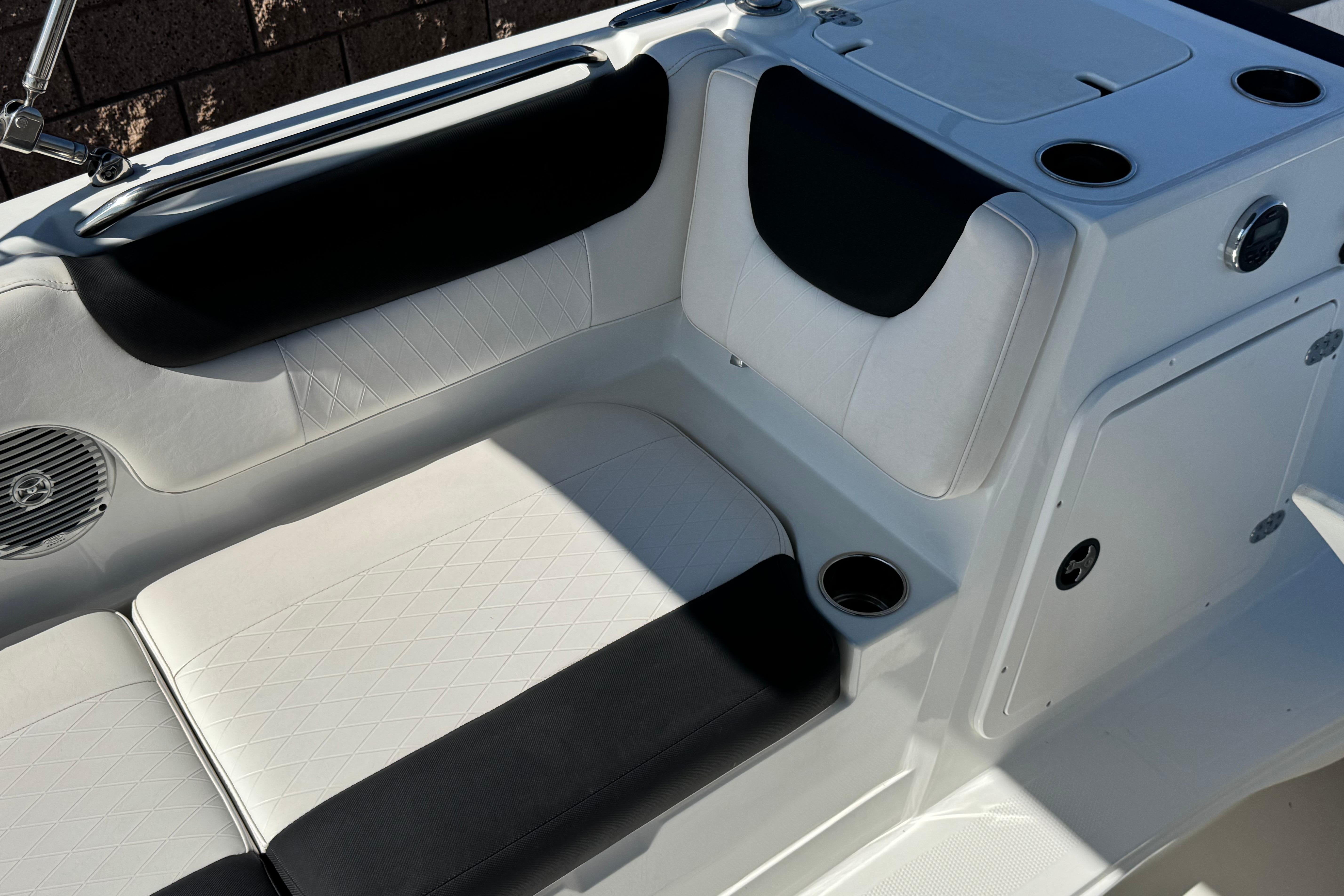 2019 Tahoe 2150 boat interior with white and black seating, cup holders, and speaker.