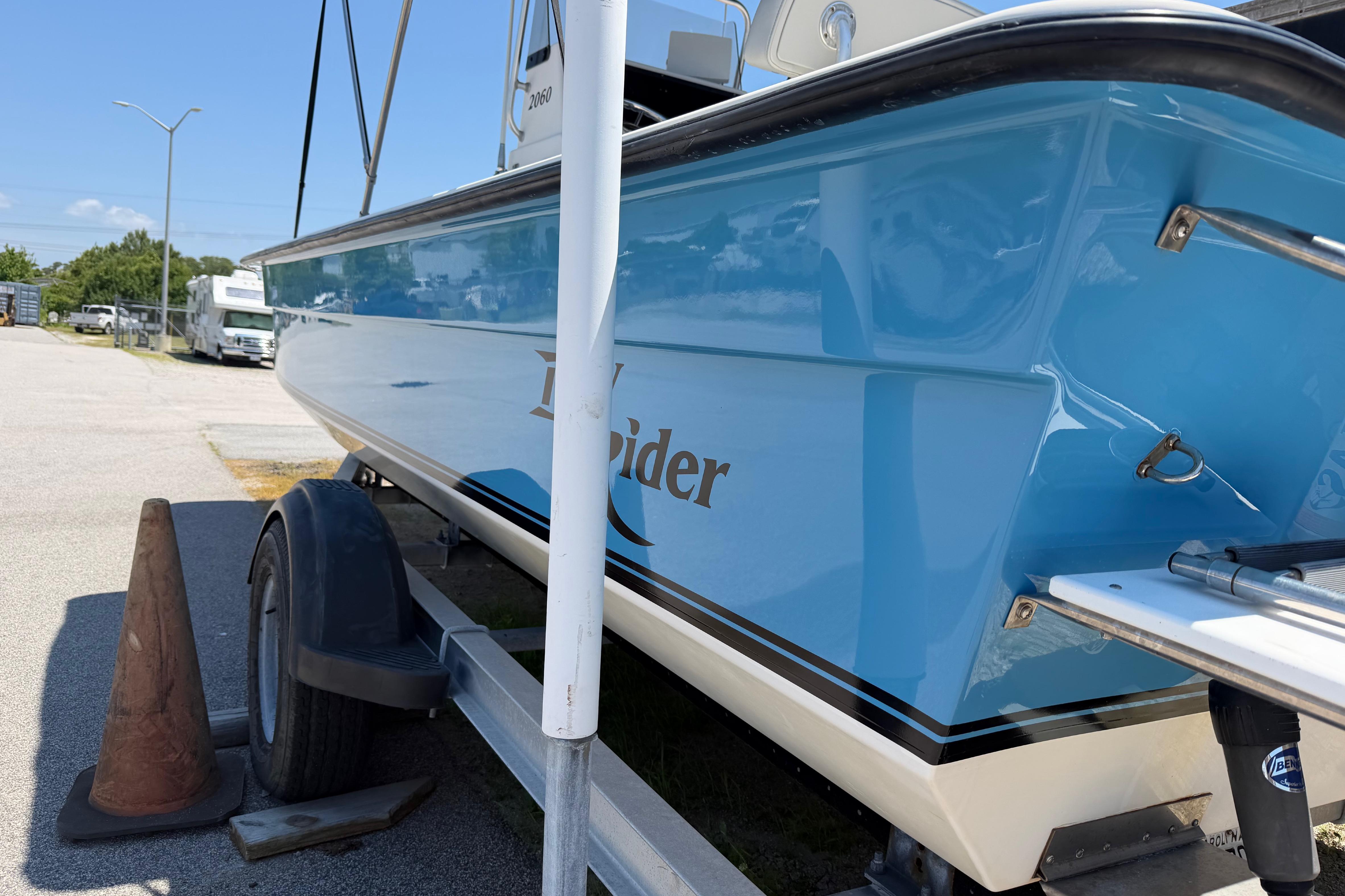2008 KenCraft Bay Rider 2060 boat on trailer, blue hull, parked outdoors.