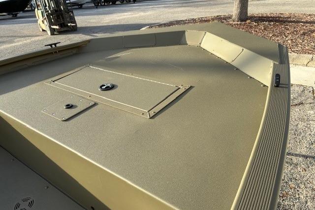 2026 Tracker Grizzly 1648 Utility boat, olive green deck, parked outdoors.
