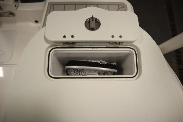 Storage compartment on 2025 Sea Fox 228 Commander boat, featuring secure latch and interior netting.