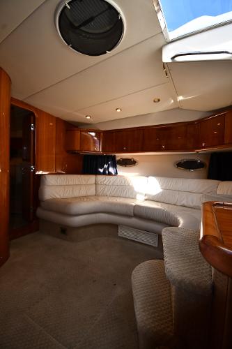 Luxurious interior of 1997 Sunseeker Camargue 47 yacht with plush seating and elegant wood finishes.
