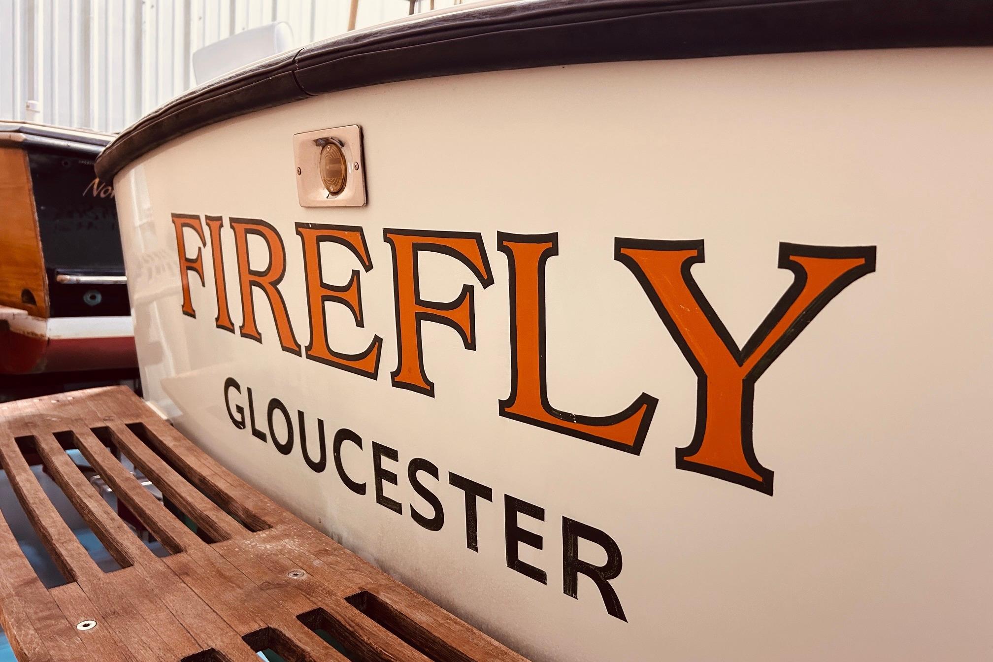 North Shore 22 boat named "Firefly" from Gloucester, 1999 model, with wooden deck detail.