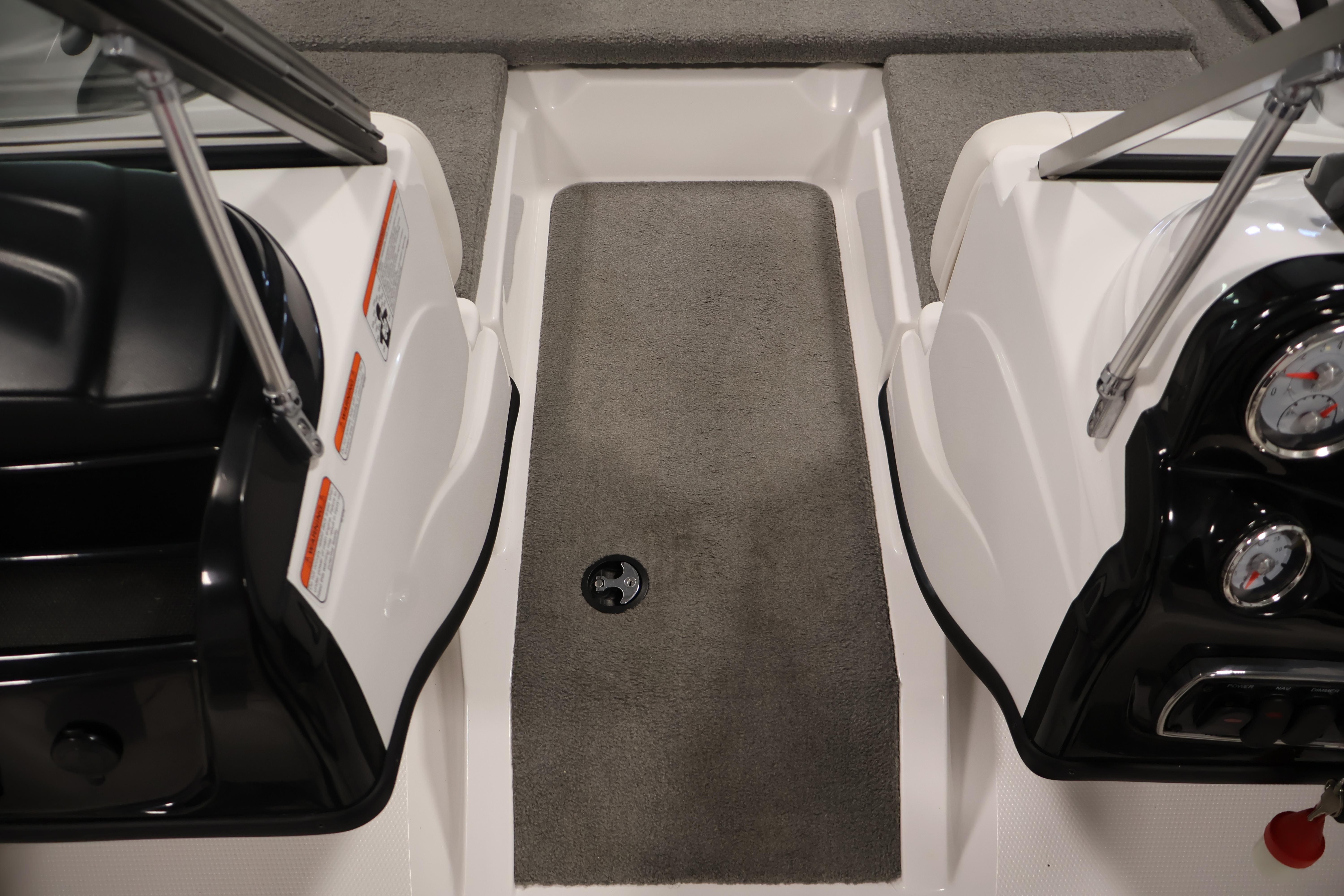 Interior view of a 2019 Nitro Z19 Sport boat, featuring gray carpet and dashboard controls.