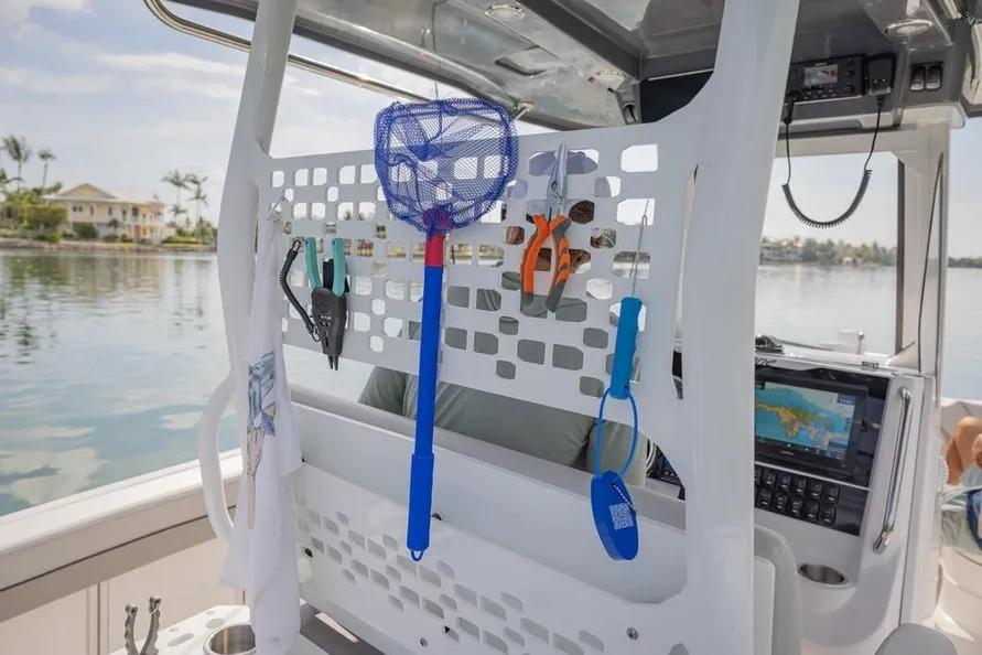 2025 Hurricane Center Console 24 OB boat interior with fishing gear and navigation equipment.