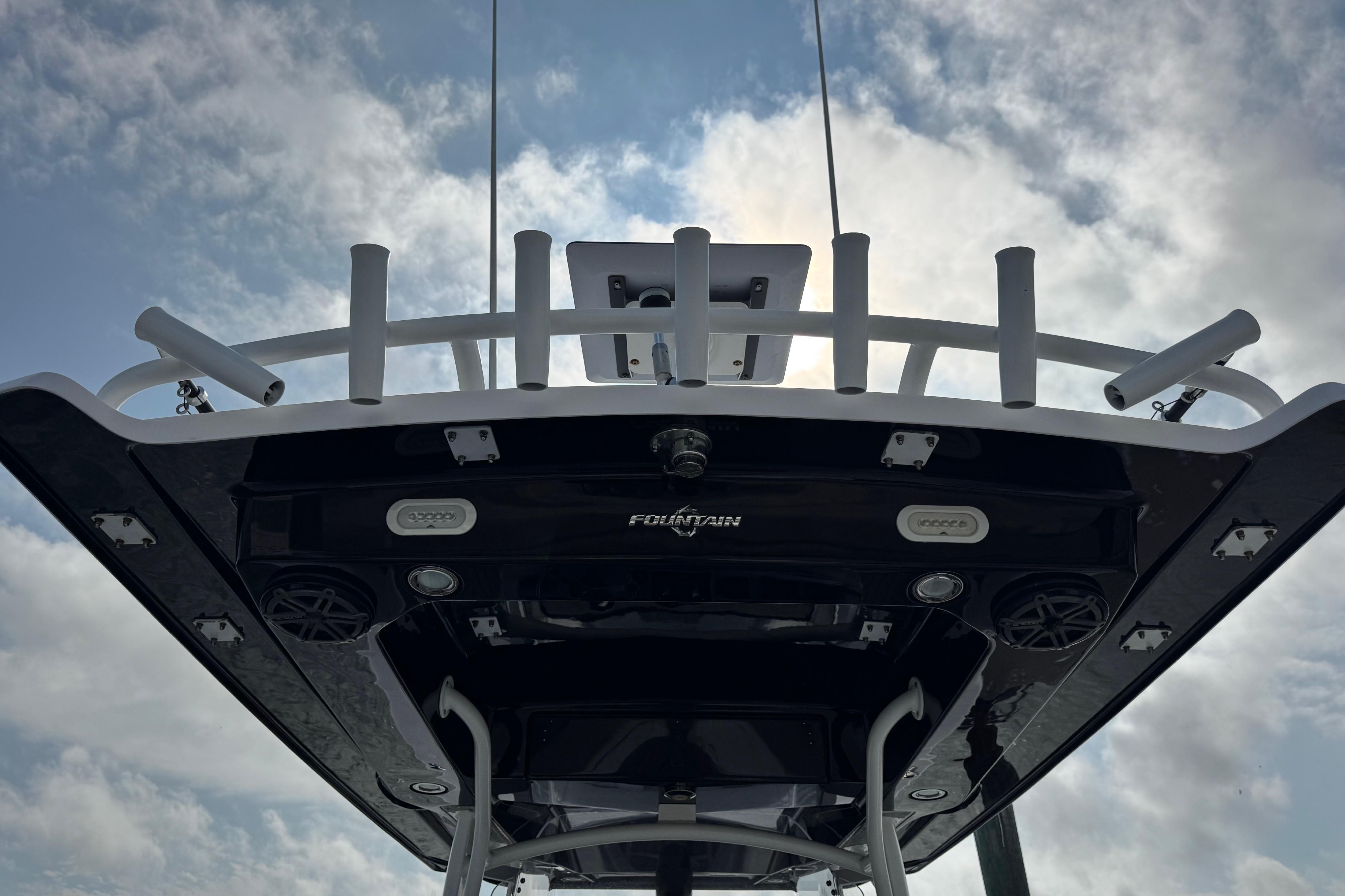 2018 Fountain 34 Center Console boat against cloudy sky, showcasing its sleek design.