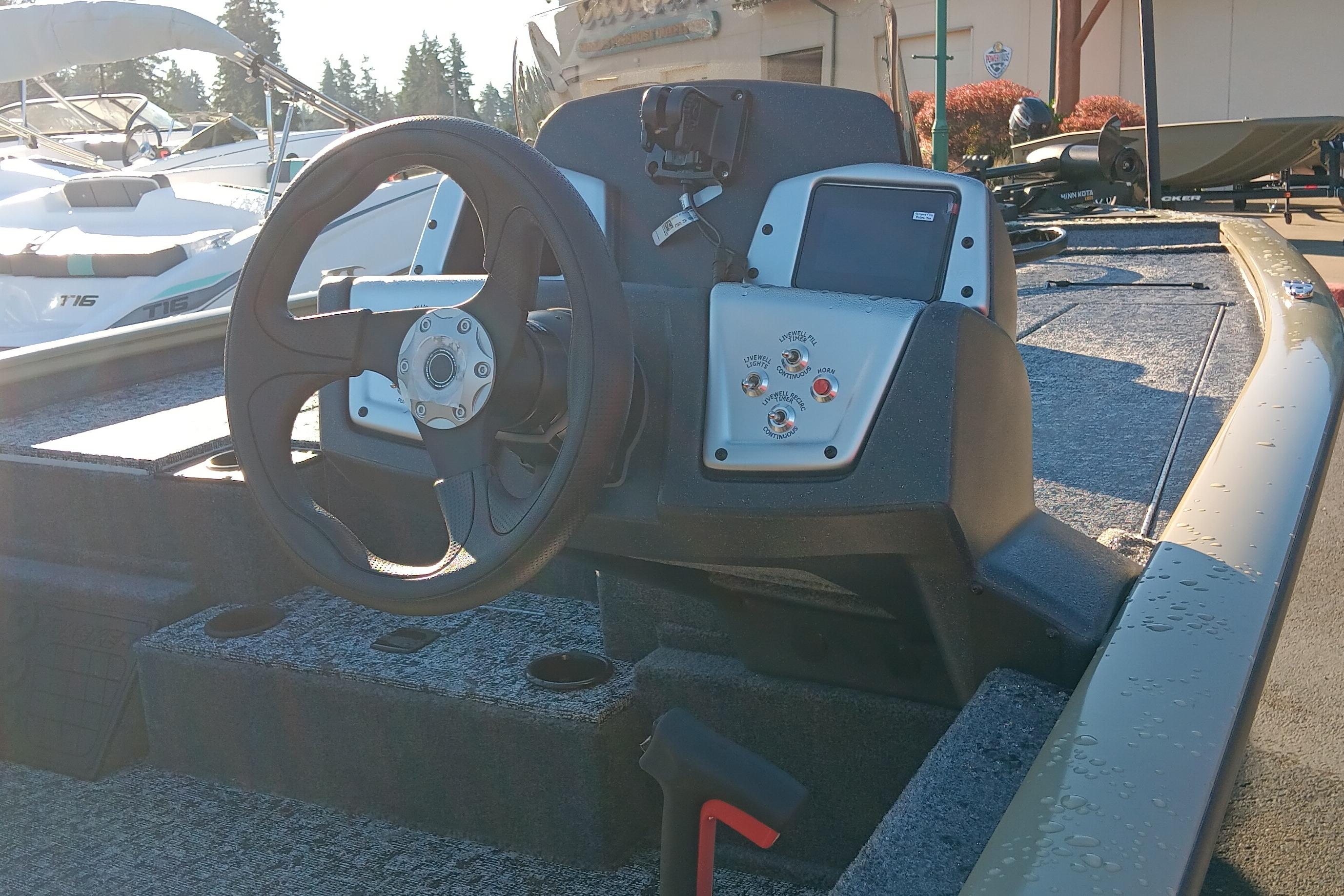 2026 Tracker Pro Team 195 boat dashboard with steering wheel and control panel.