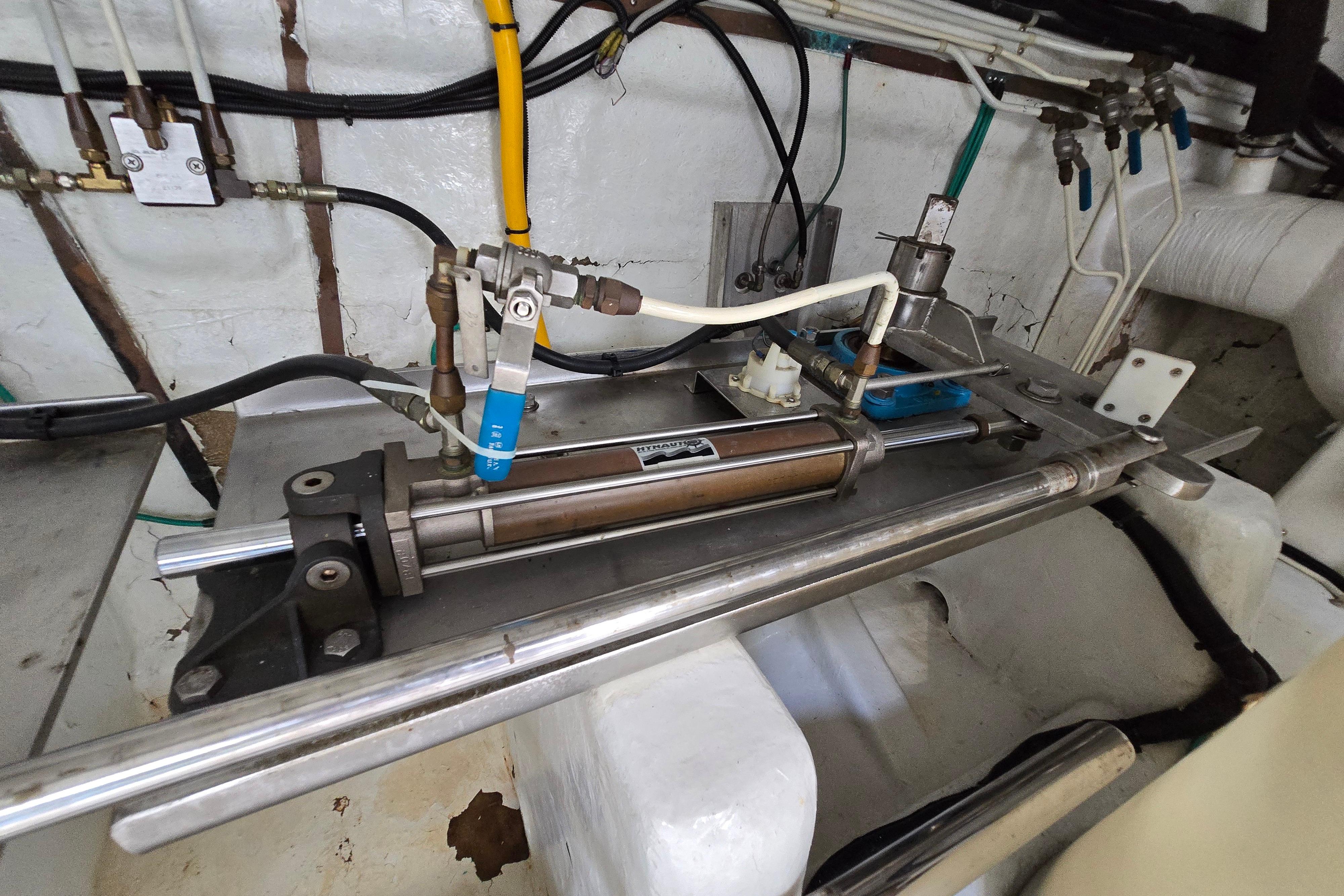 Hydraulic system in a 2004 Grand Harbour 58 yacht engine room, featuring pipes and valves.