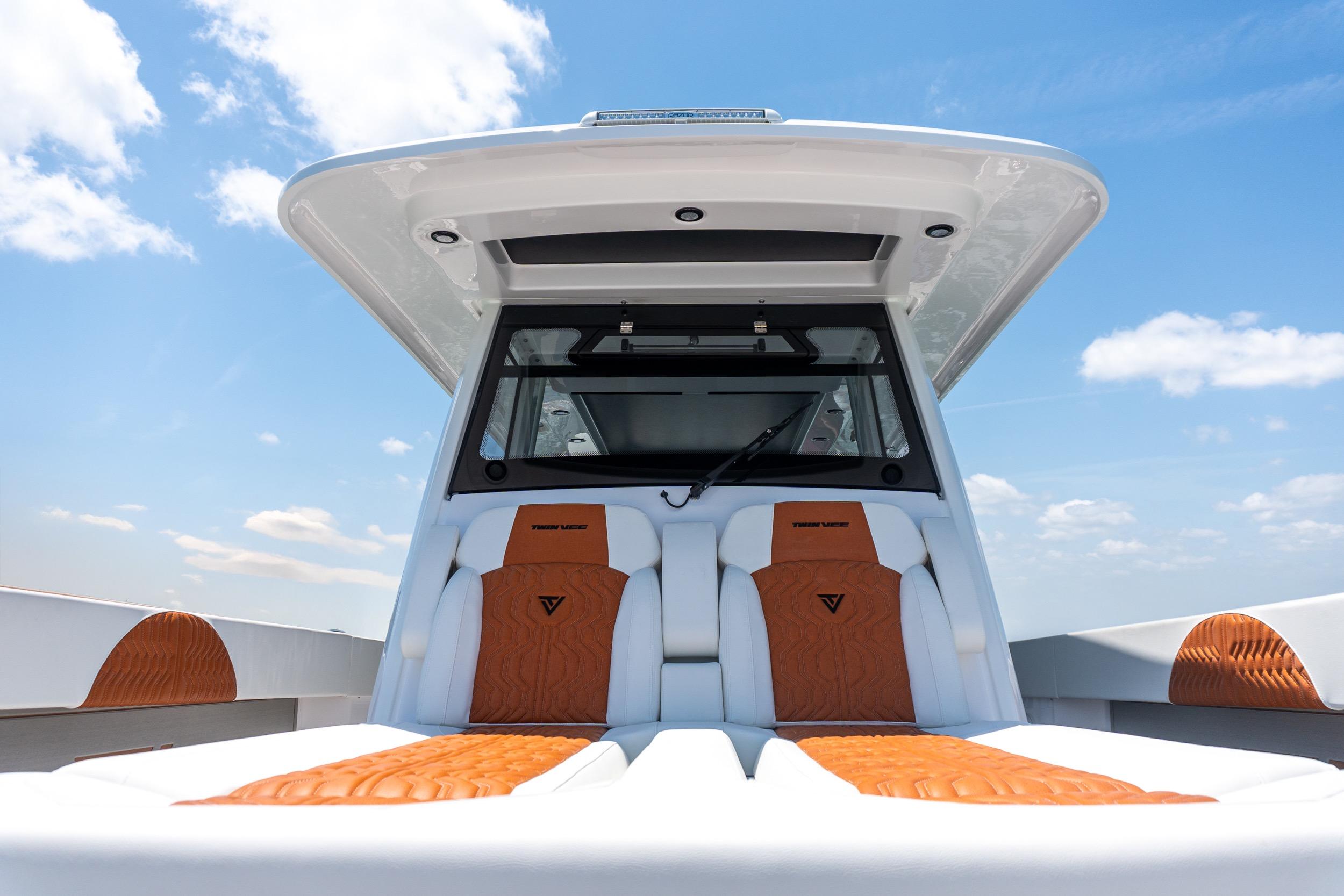 2026 Twin Vee 400 GFX2 CC boat interior with luxurious seating under a clear blue sky.