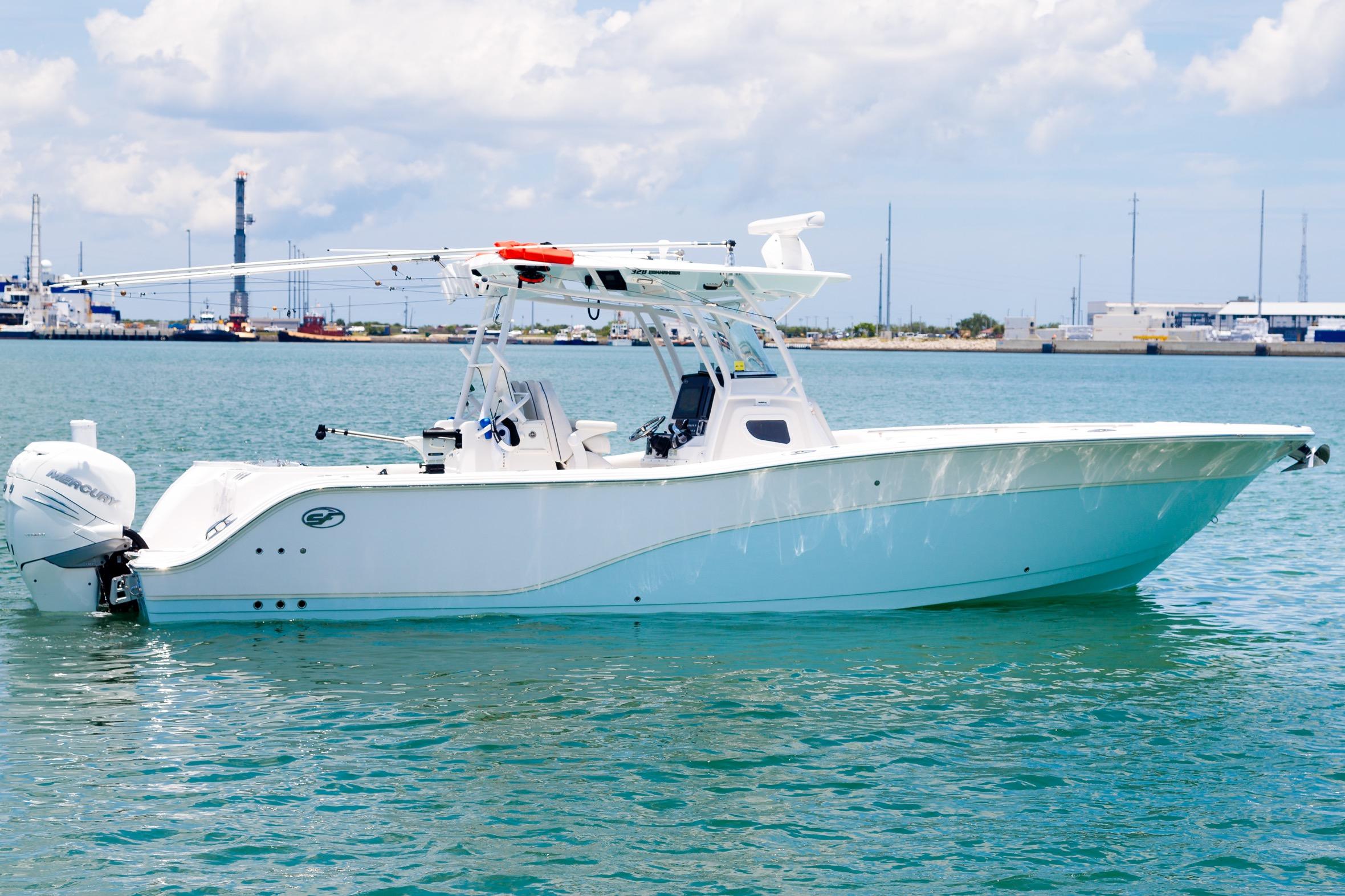 2021 Sea Fox 328 Commander boat on calm water, with clear sky background.