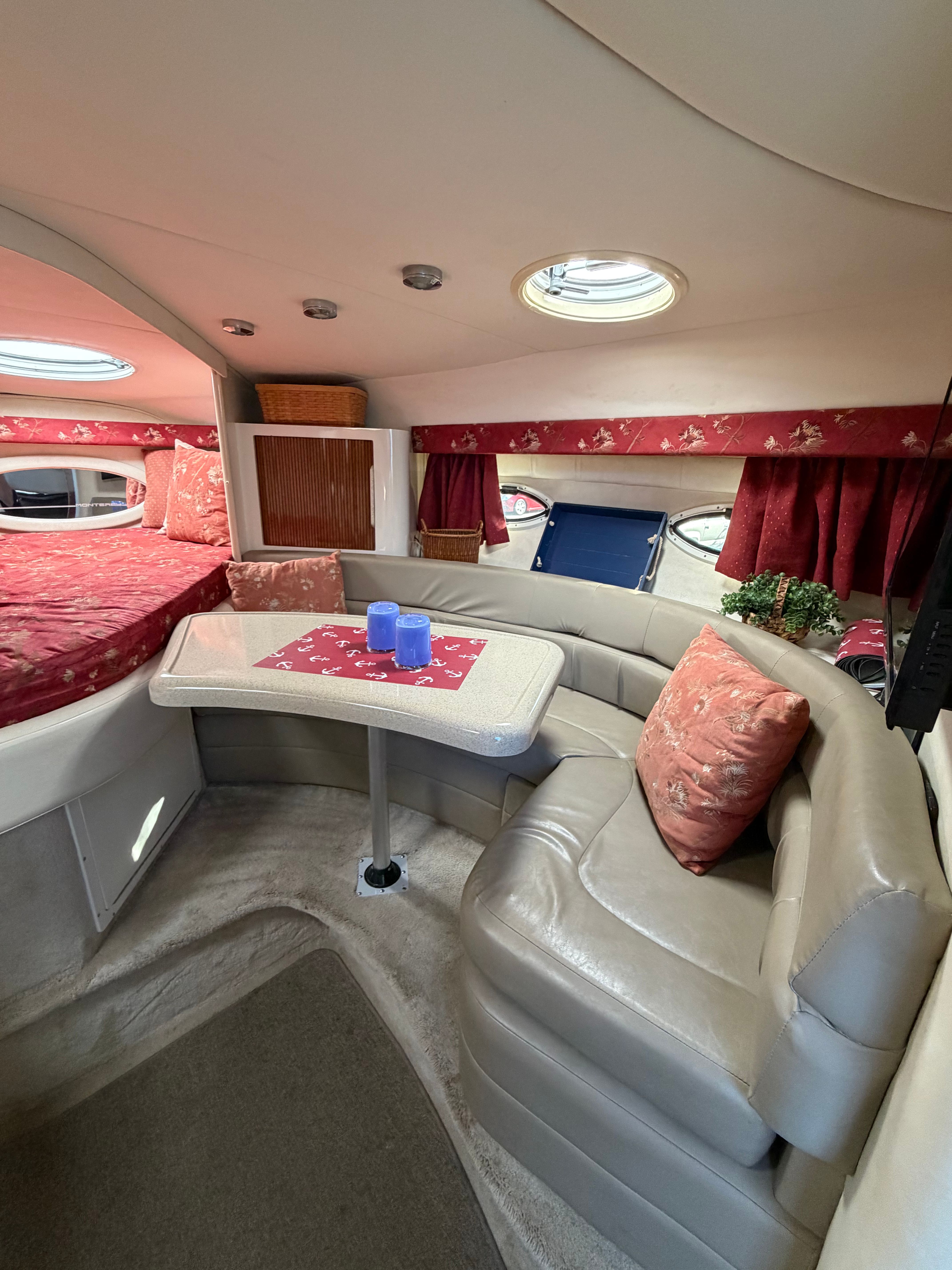 Interior of a Monterey 322 Cruiser with a cozy seating area and table.