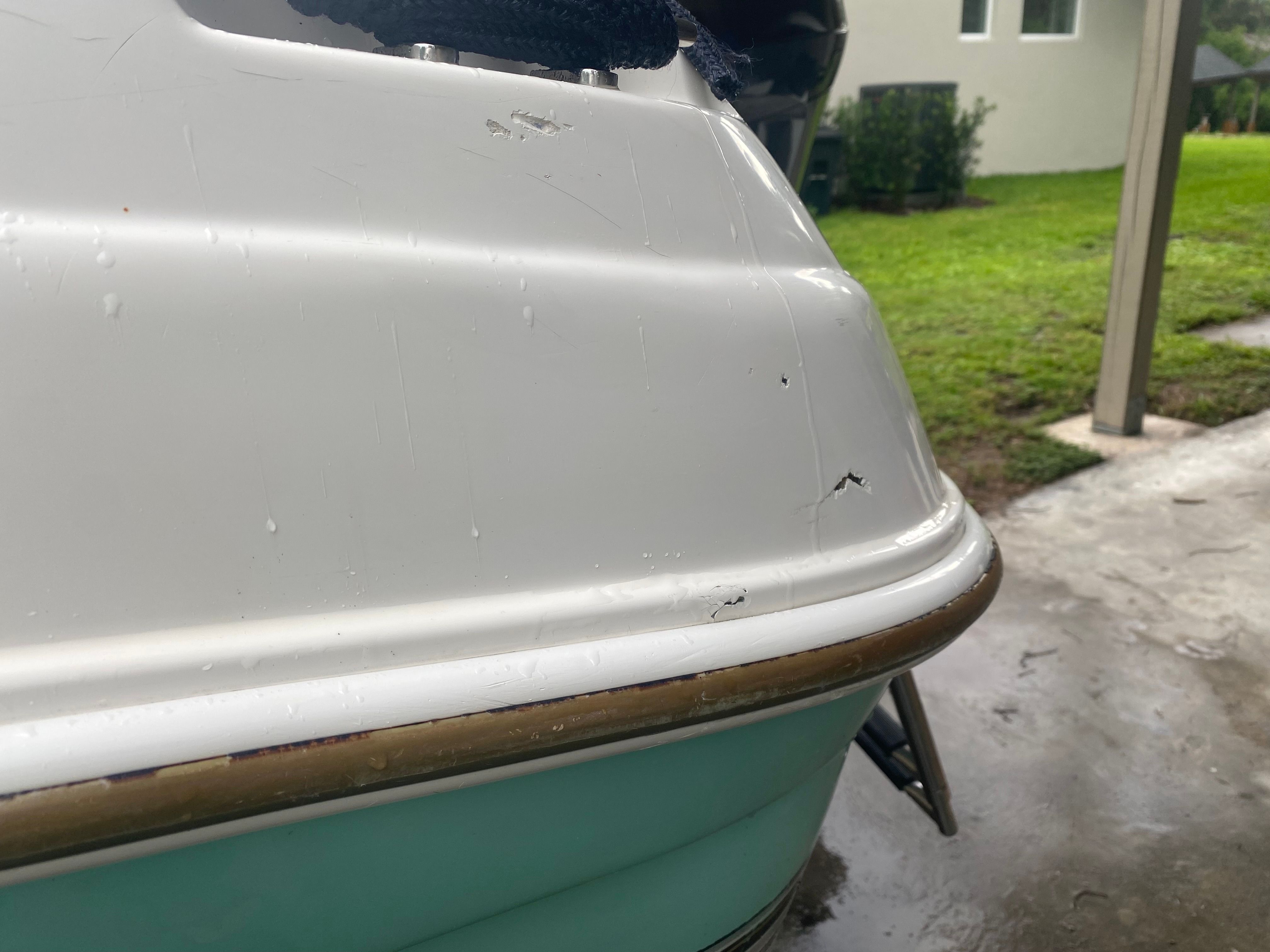 Close-up of a 2003 Aquasport 201 Osprey boat hull, showing minor scratches.