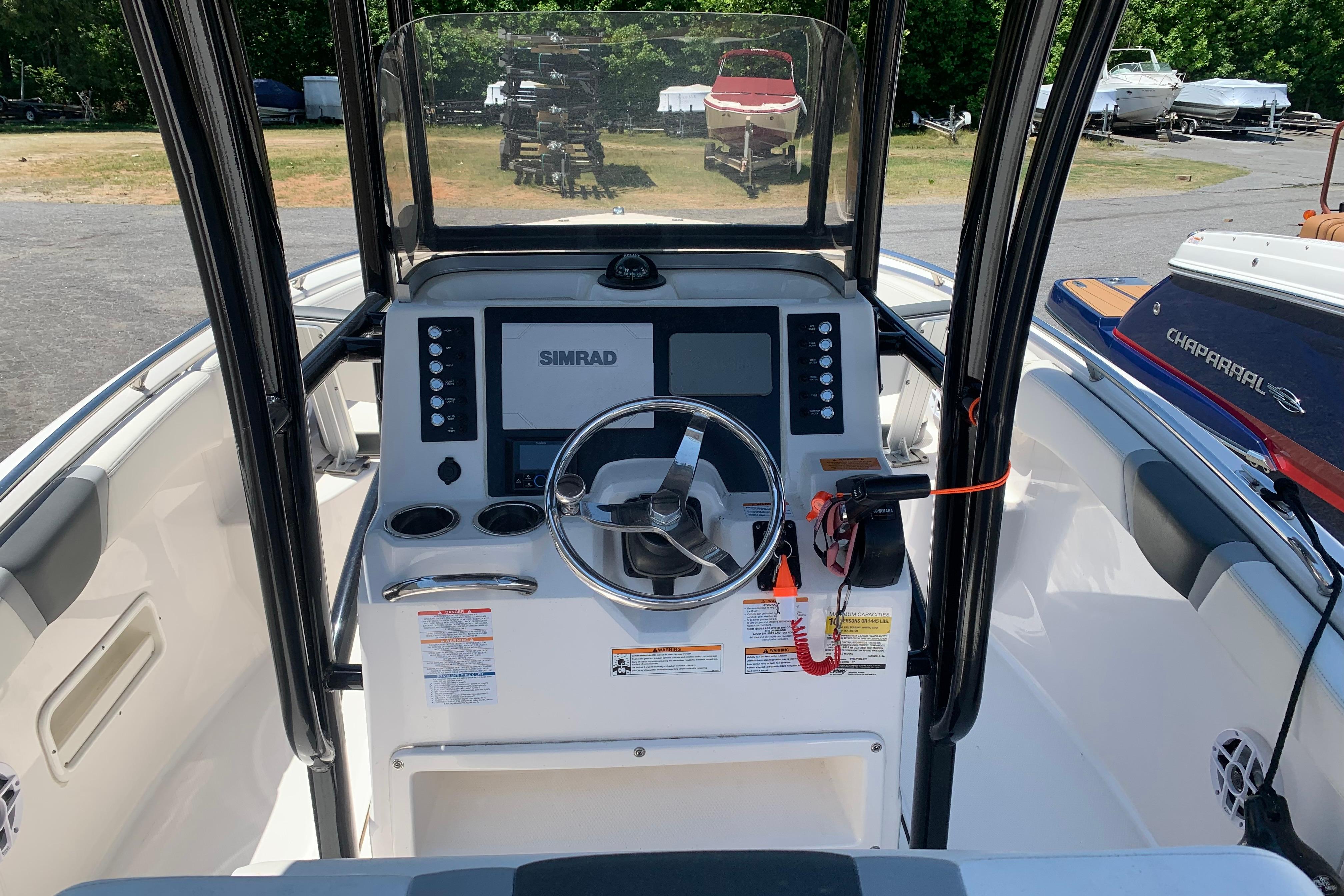 2023 Robalo R222 Center Console boat dashboard with steering wheel and Simrad display.