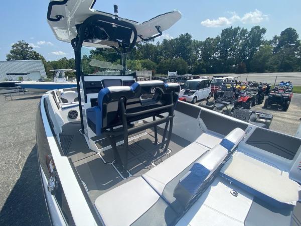 2021 Scarab 255 Open ID boat with seating and console, parked outdoors.