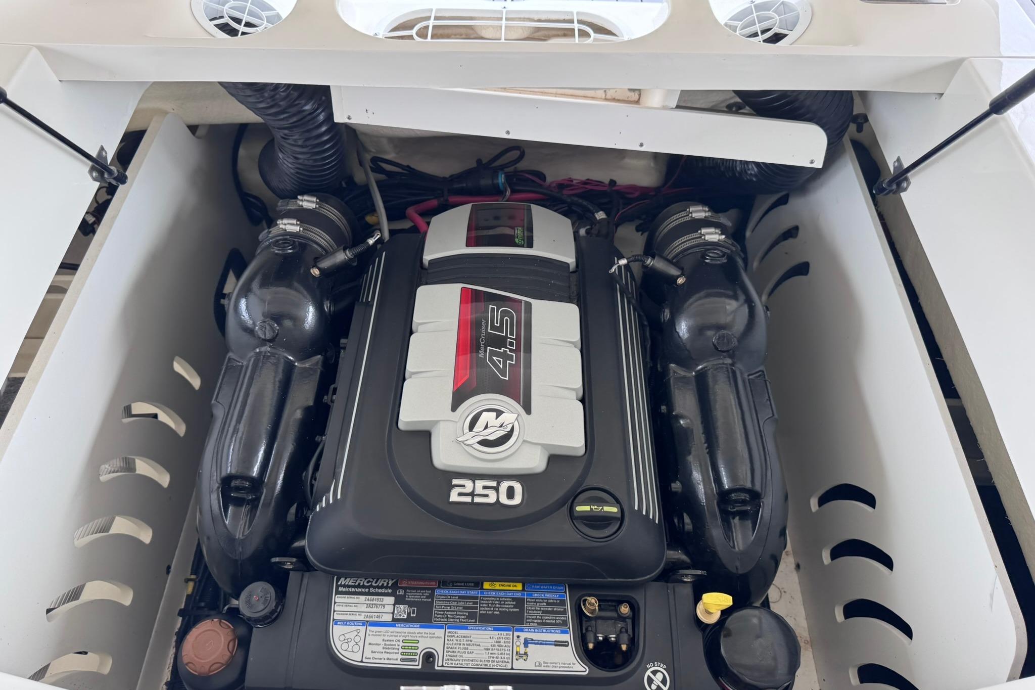 Engine compartment of a 2021 Sea Ray SPX 230 boat, featuring a Mercury 4.5L 250 HP engine.
