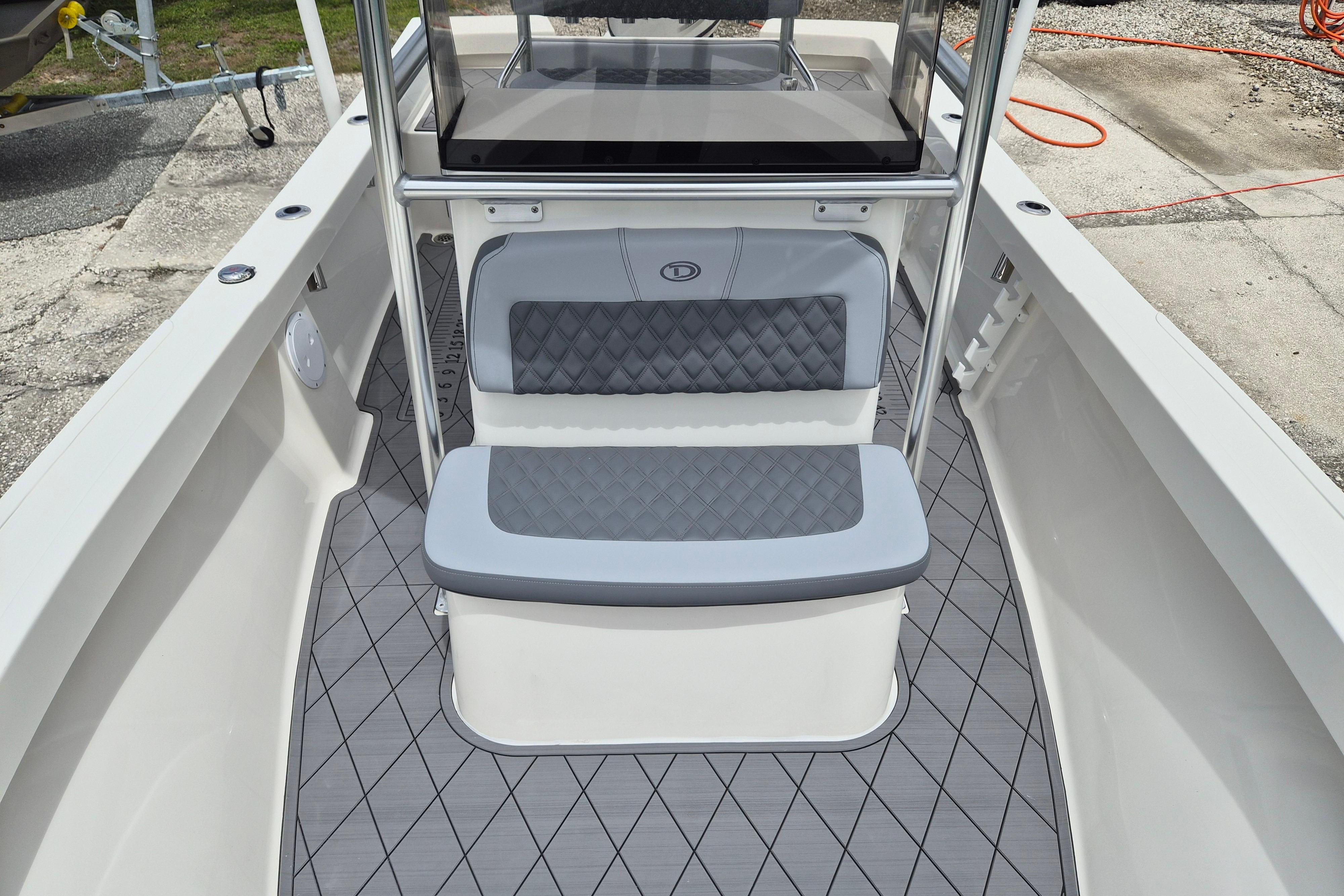 2026 Defiance Catalina 190 boat interior with cushioned seating and diamond-patterned flooring.