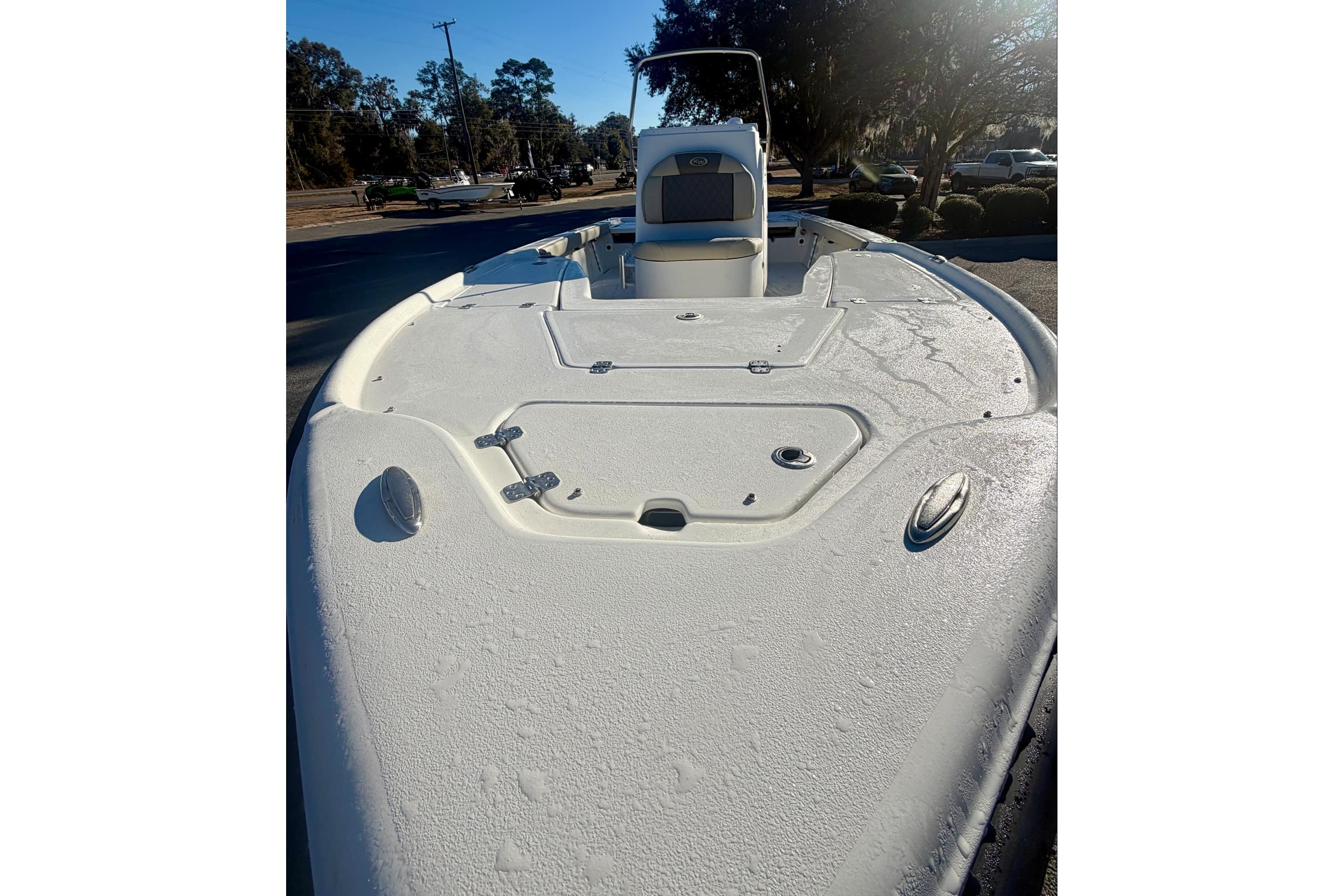2026 Key West 210 Bay Reef boat deck under sunlight, showcasing sleek design and spacious layout.