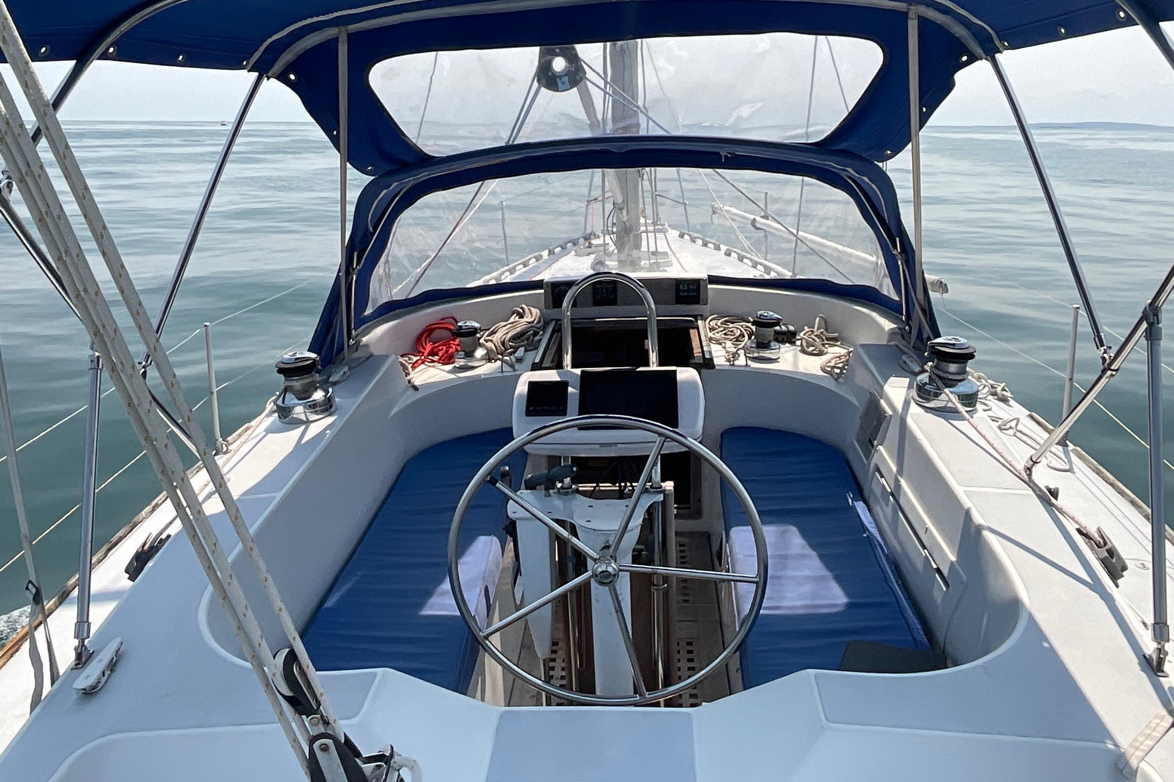 1988 Westerly Corsair 36 sailboat cockpit with blue canopy and steering wheel.