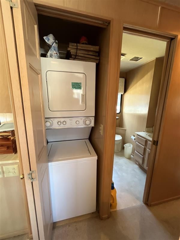 Stacked washer and dryer in 1998 Sumerset houseboat interior, adjacent to bathroom.