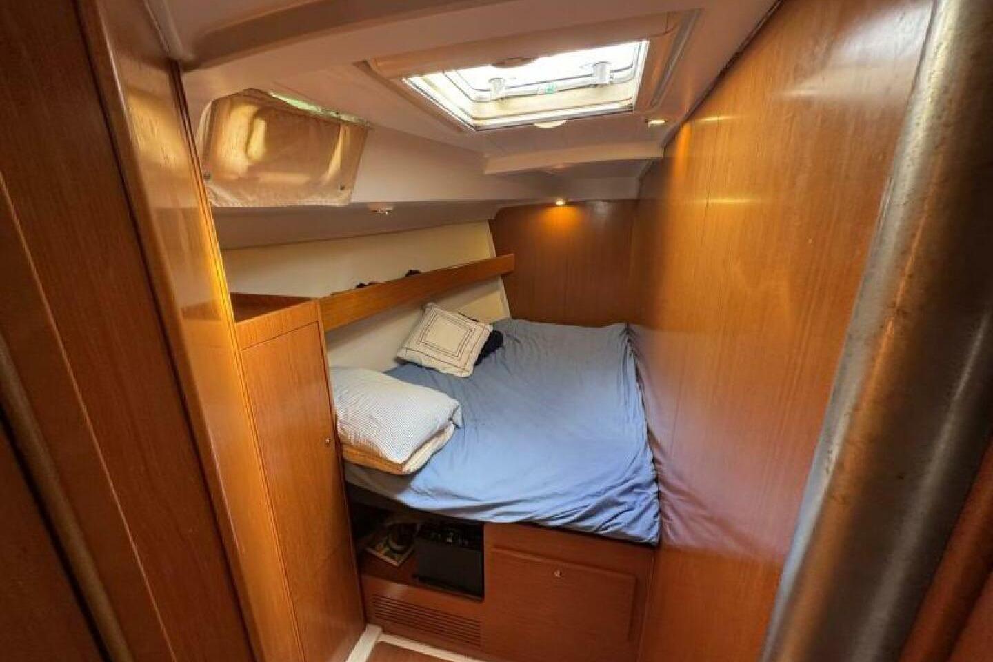 Cozy cabin interior of 2006 Beneteau Cyclades 50 sailboat with wooden finish and skylight.