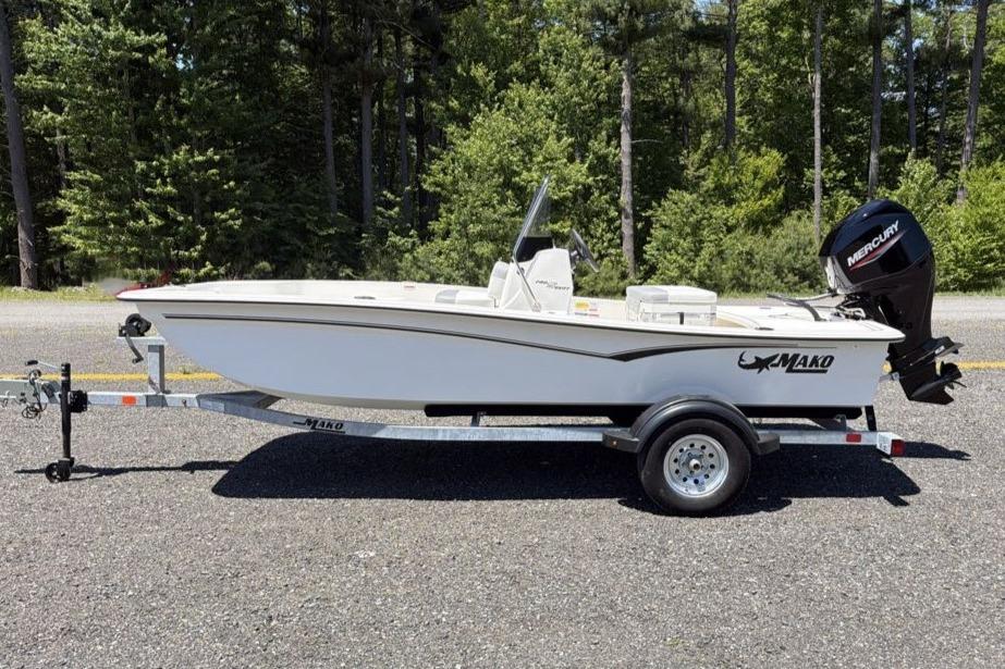 2026 Mako Pro Skiff 15 CC boat on trailer, parked outdoors.