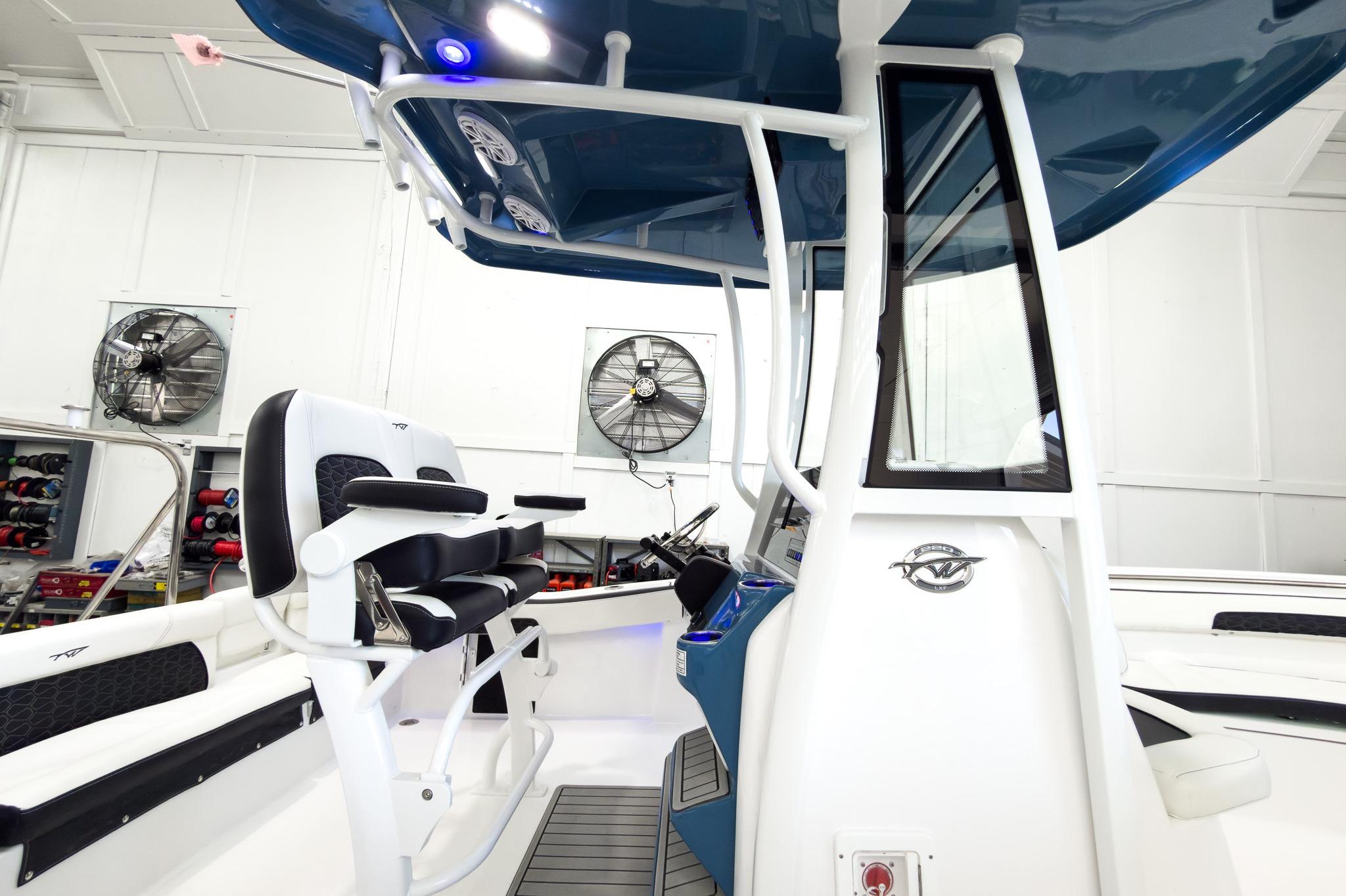 The image shows the interior of a 2026 Tidewater 220 LXF boat with modern seating and controls.