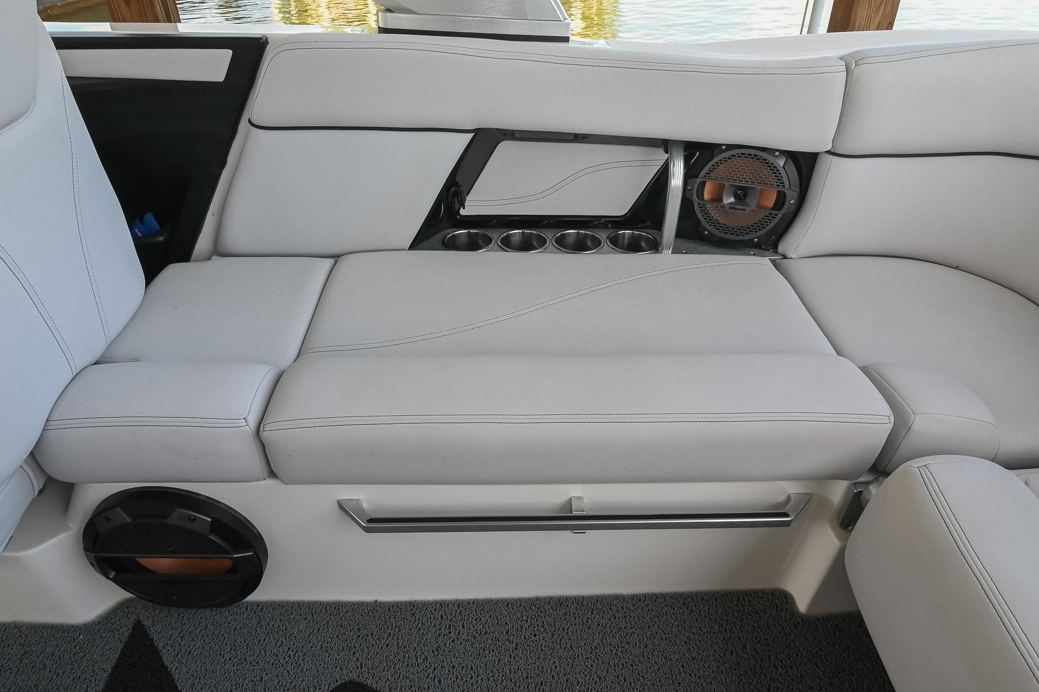 2018 MasterCraft X23 boat interior with cushioned seating and built-in cup holders.